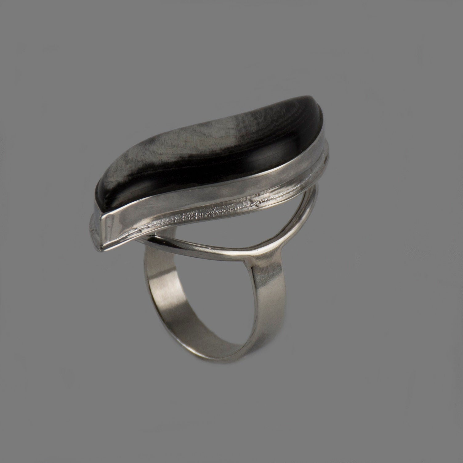 Handmade silver ring featuring a polished natural horn cabochon, showcasing a unique boho design.