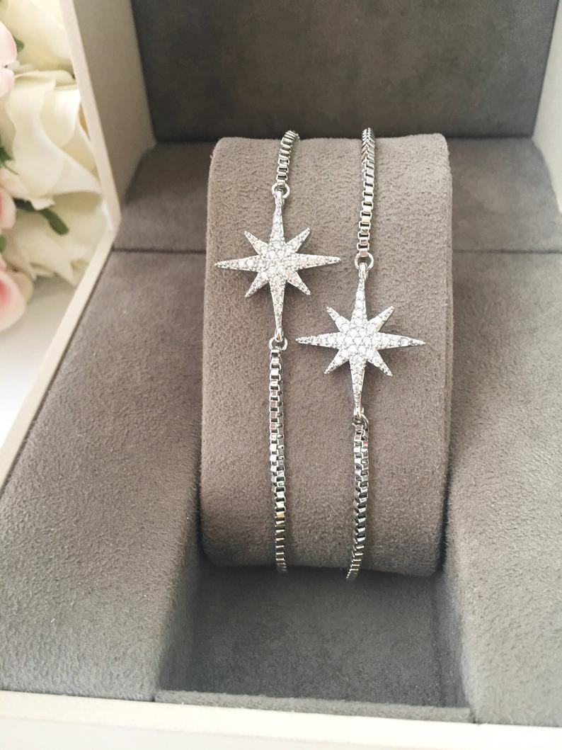 A handmade silver star bracelet featuring an adjustable design and a sparkling star charm, crafted from tarnish-resistant stainless steel.