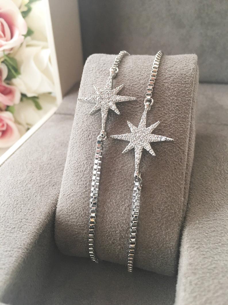 A handmade silver star bracelet featuring an adjustable design and a sparkling star charm, crafted from tarnish-resistant stainless steel.