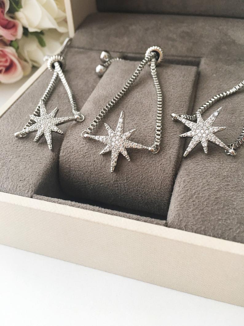 A handmade silver star bracelet featuring an adjustable design and a sparkling star charm, crafted from tarnish-resistant stainless steel.