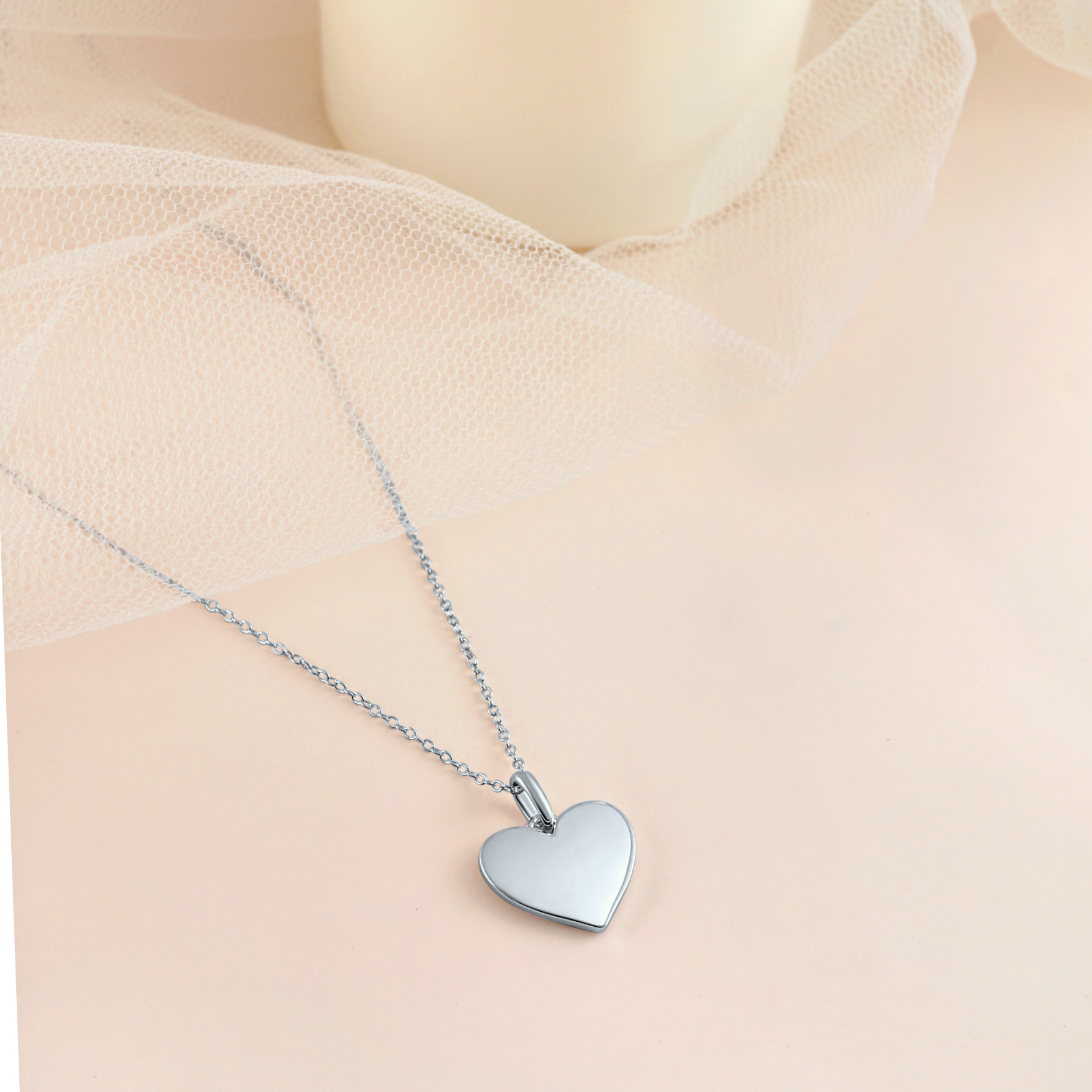 A stunning silver necklace featuring a heart-shaped pendant adorned with delicate stars, symbolizing elegance and self-love.