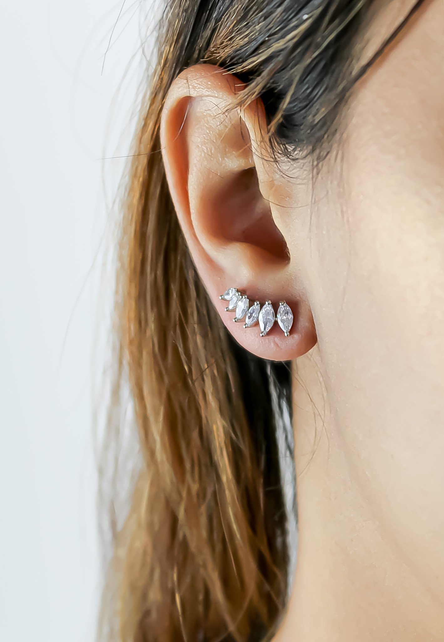 A pair of elegant silver-plated stepping earrings designed for pierced ears, featuring a modern and lightweight design.