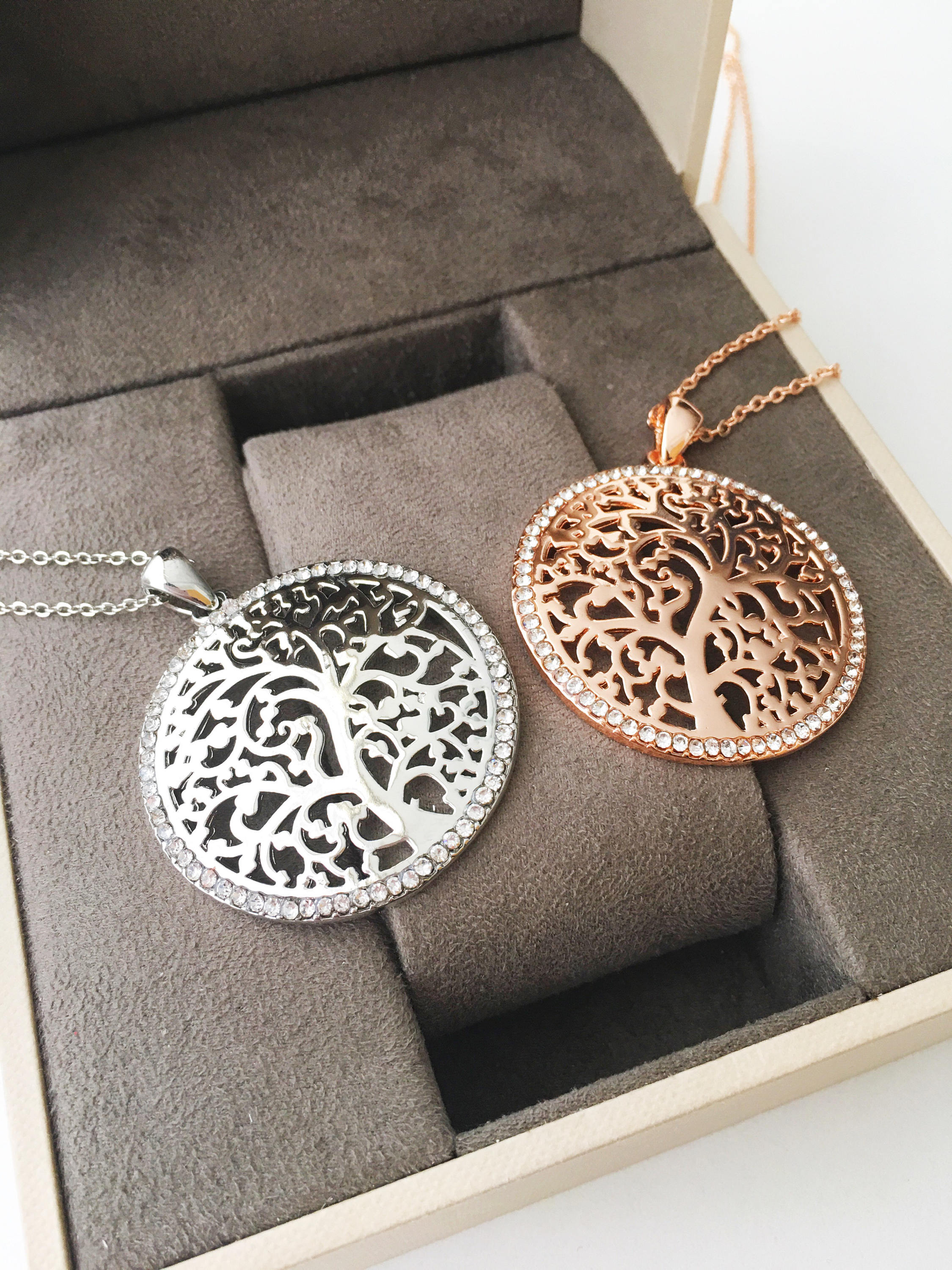 Silver Tree of Life Necklace featuring a detailed charm on a long stainless steel chain, symbolizing family and connection.