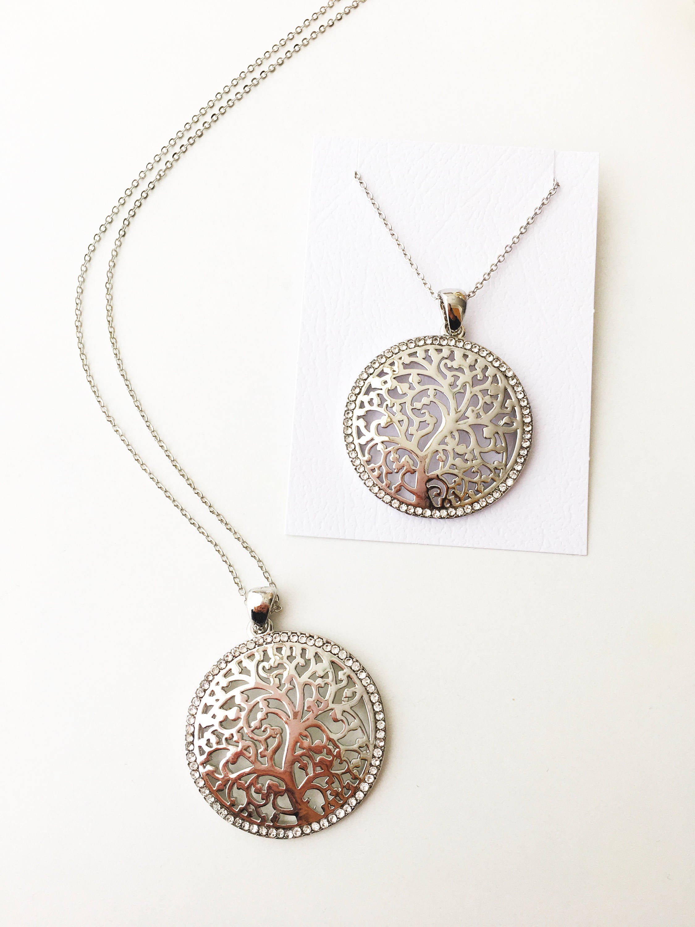 Silver Tree of Life Necklace featuring a detailed charm on a long stainless steel chain, symbolizing family and connection.