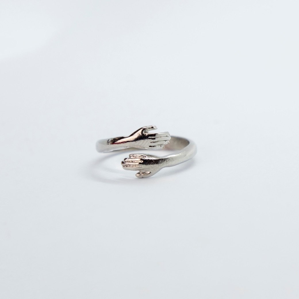 Couple Stackable Love Ring in silver and gold, featuring love hugging hands design, adjustable size for any finger.