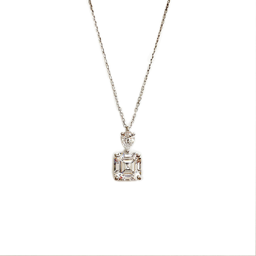 A delicate emerald cut white sapphire necklace made of 925 sterling silver with real white gold filling, featuring an adjustable chain.