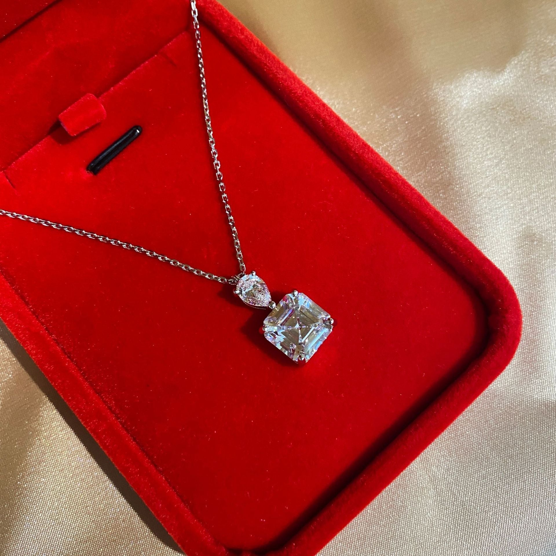 A delicate emerald cut white sapphire necklace made of 925 sterling silver with real white gold filling, featuring an adjustable chain.