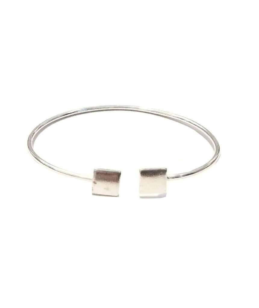 A simple geometric bracelet in gold and silver, showcasing its adjustable design and elegant craftsmanship.