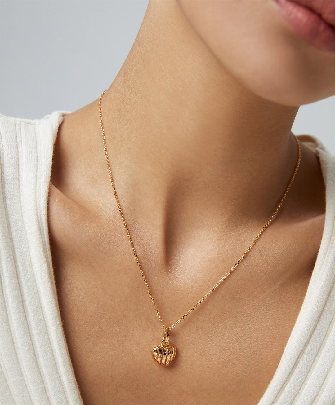 A delicate three-dimensional hollow necklace made of gold vermeil, showcasing its intricate design and adjustable chain.