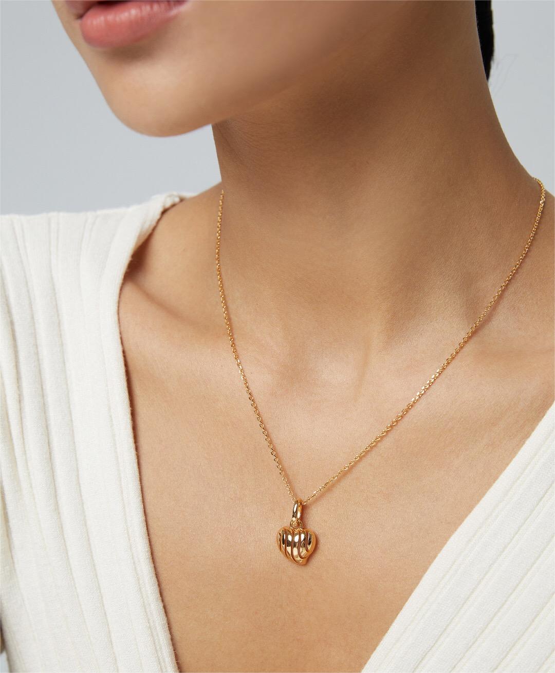 A delicate three-dimensional hollow necklace made of gold vermeil, showcasing its intricate design and adjustable chain.