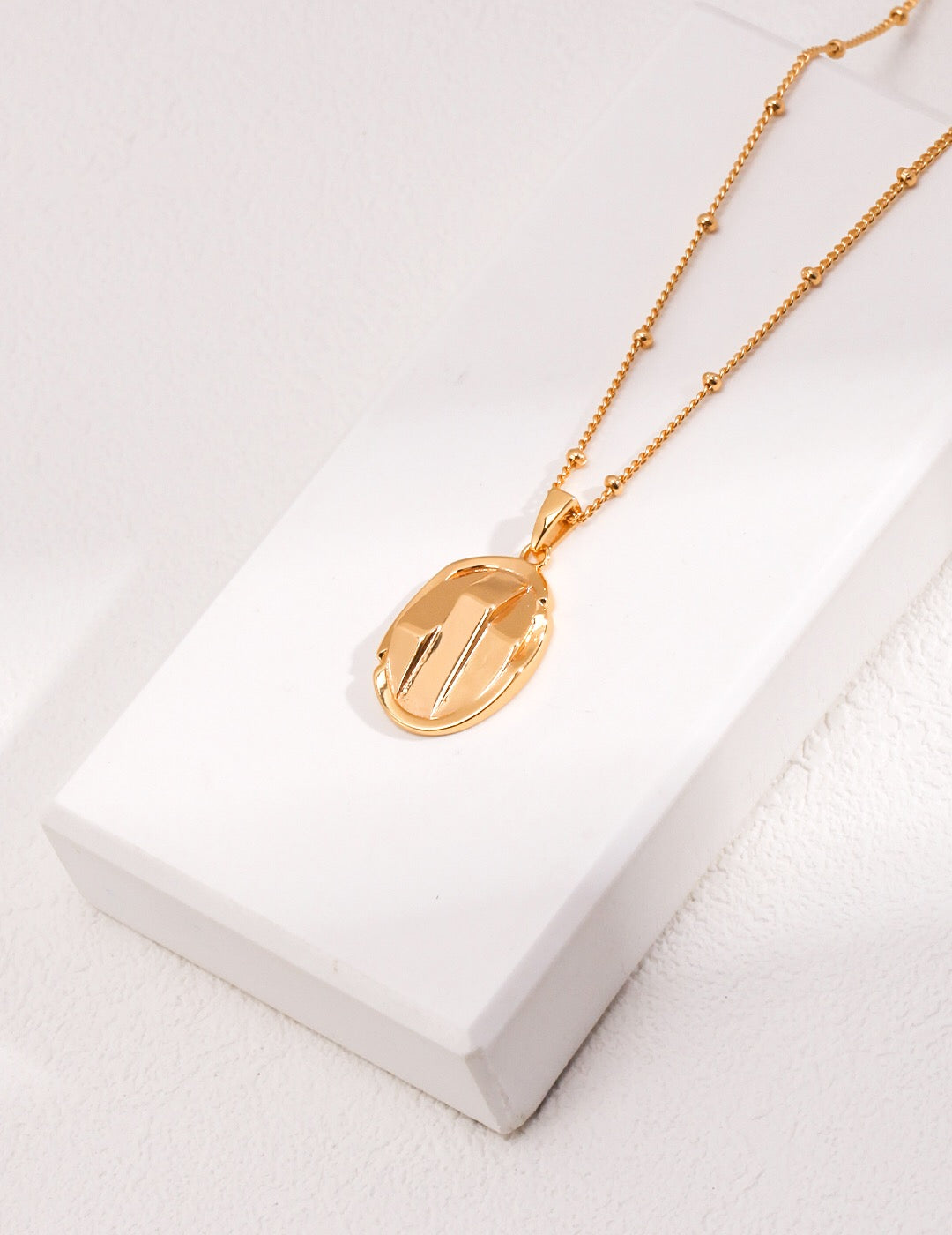 A delicate Simple Oval Pendant Necklace made of gold vermeil, featuring an adjustable chain and a minimalist oval pendant design.