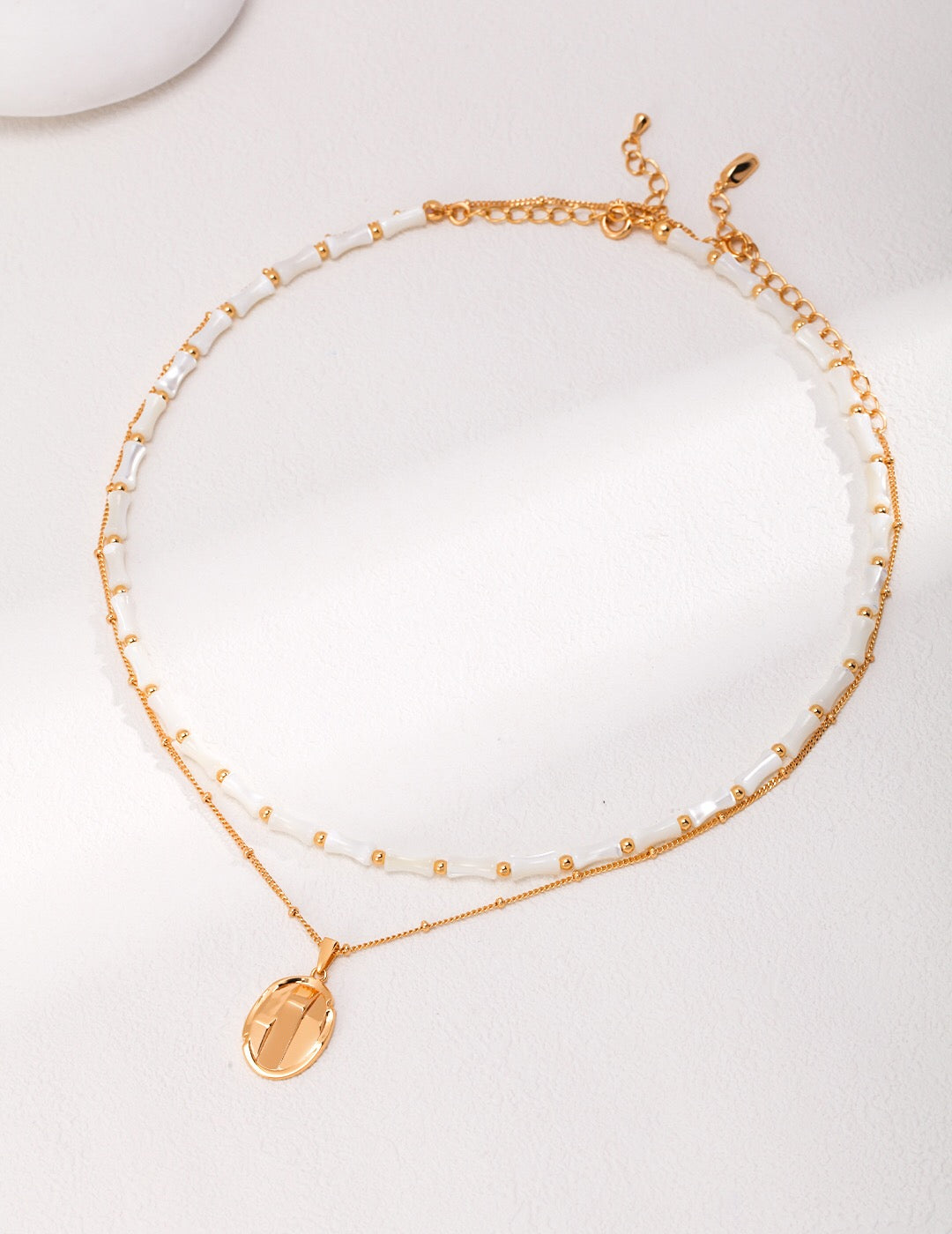 A delicate Simple Oval Pendant Necklace made of gold vermeil, featuring an adjustable chain and a minimalist oval pendant design.