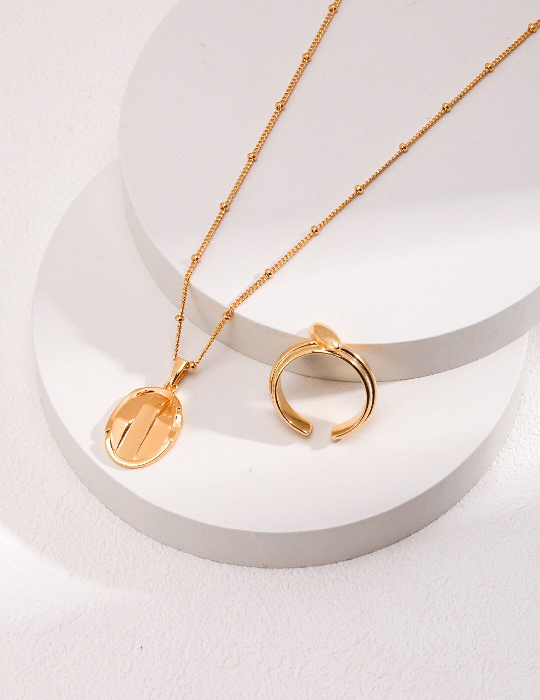 A delicate Simple Oval Pendant Necklace made of gold vermeil, featuring an adjustable chain and a minimalist oval pendant design.