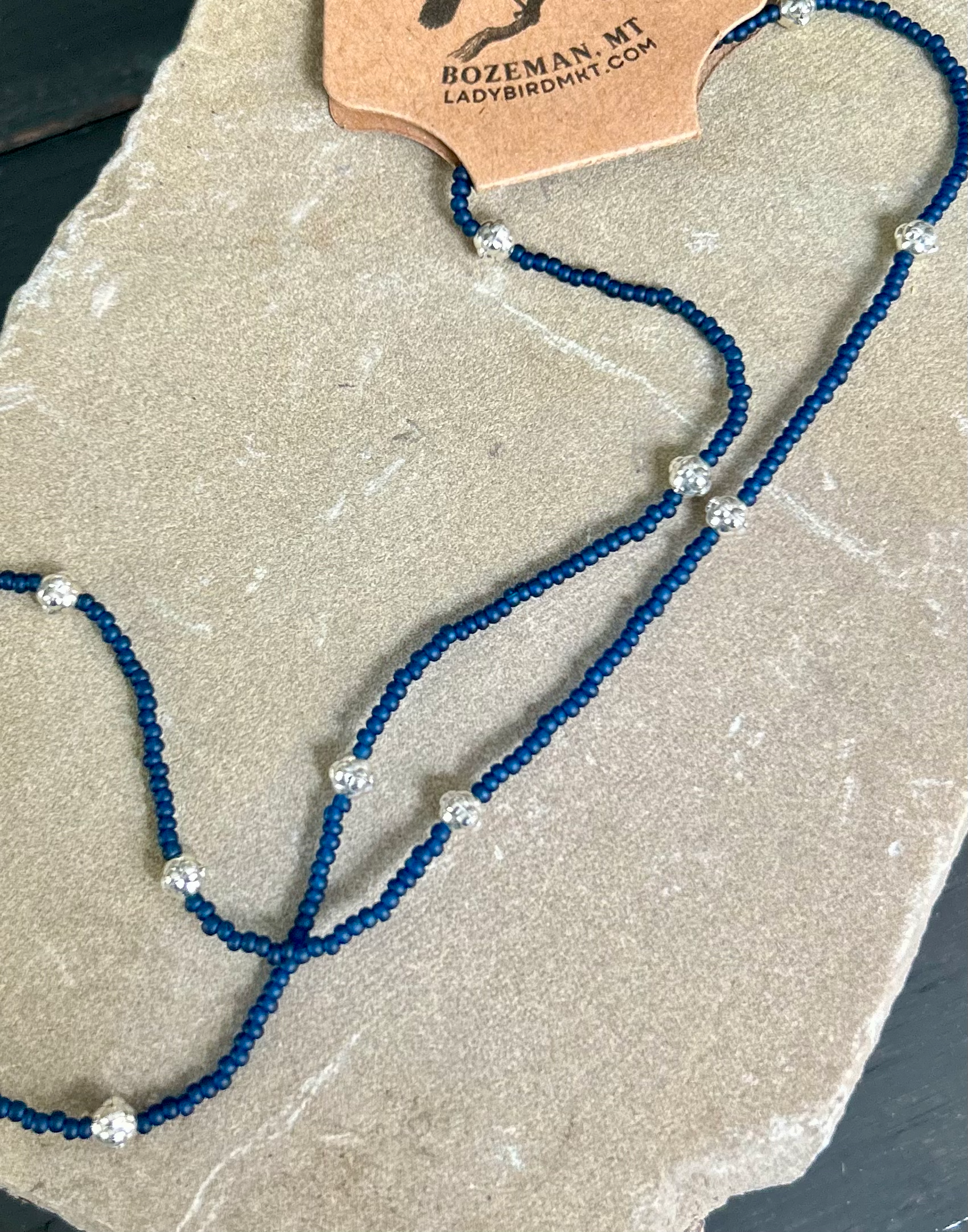 Simply Delicate Navy Blue Seed Bead Stretchy Necklace featuring chunky gold metallic accents, showcasing a stylish Boho design.