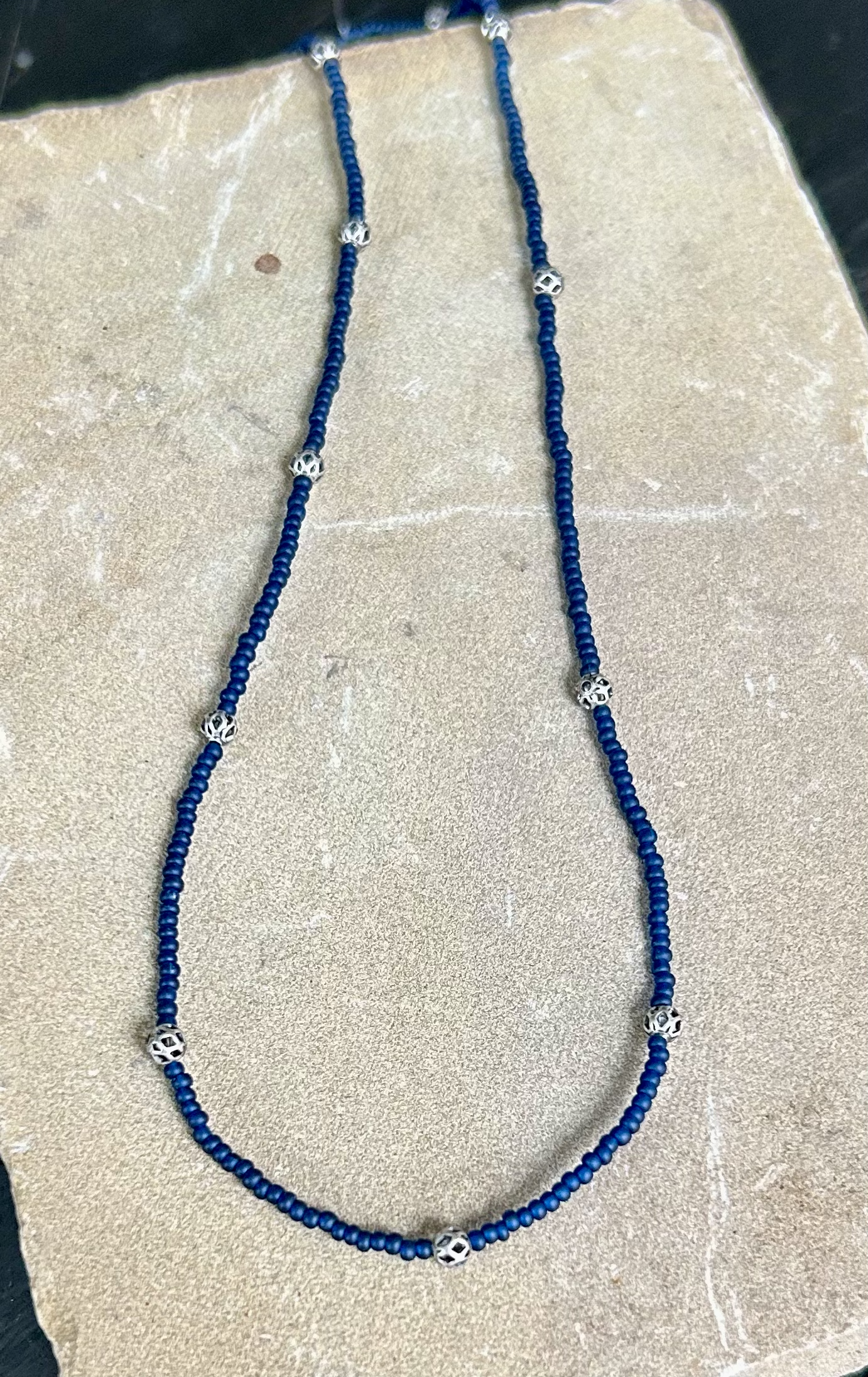 Simply Delicate Navy Blue Seed Bead Stretchy Necklace featuring antique silver lattice beads on elastic cording, perfect for Boho style.