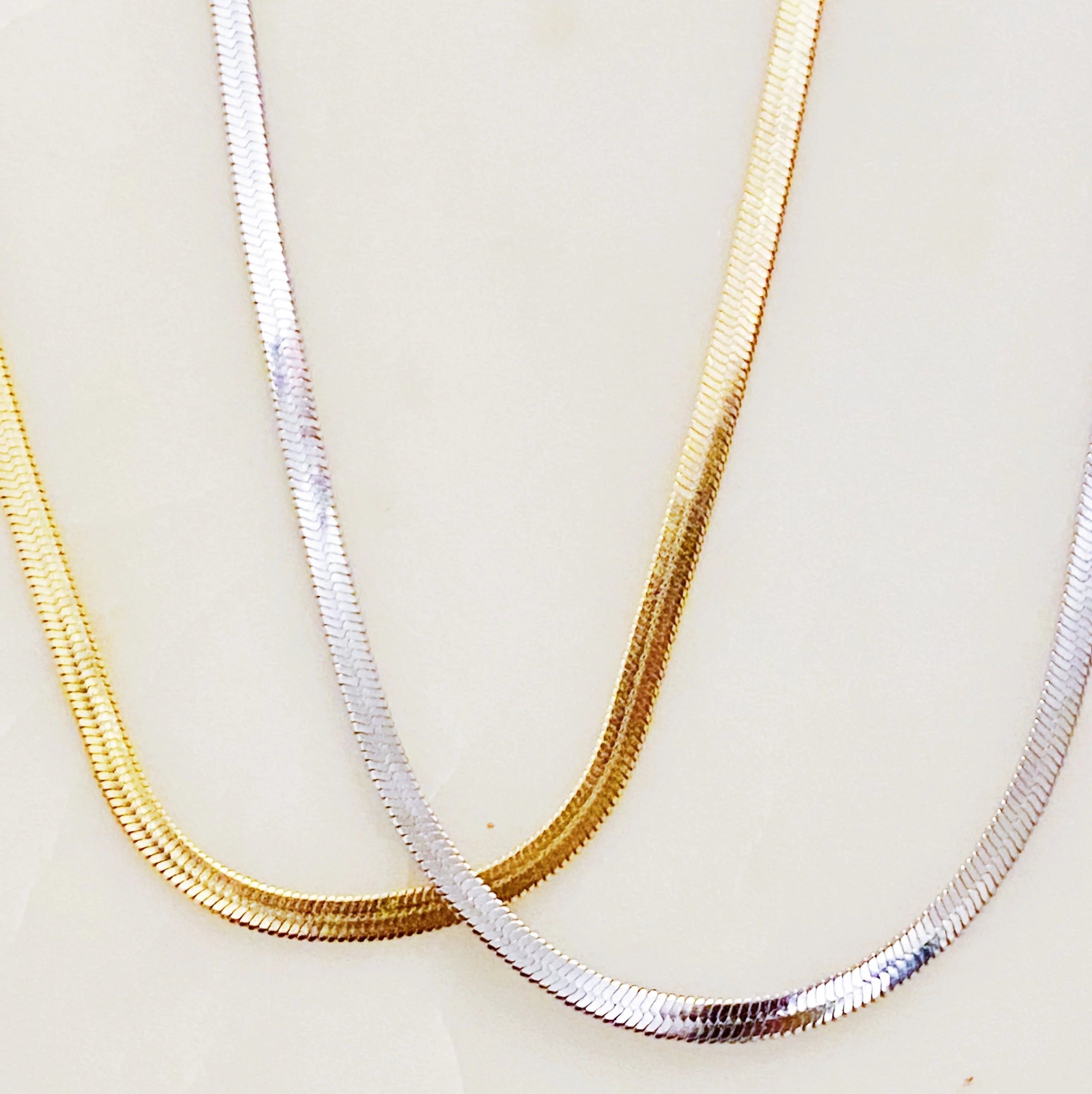 Simply Herringbone Chain Necklace featuring a classic herringbone design in stainless steel with 18K gold plating, adjustable length.