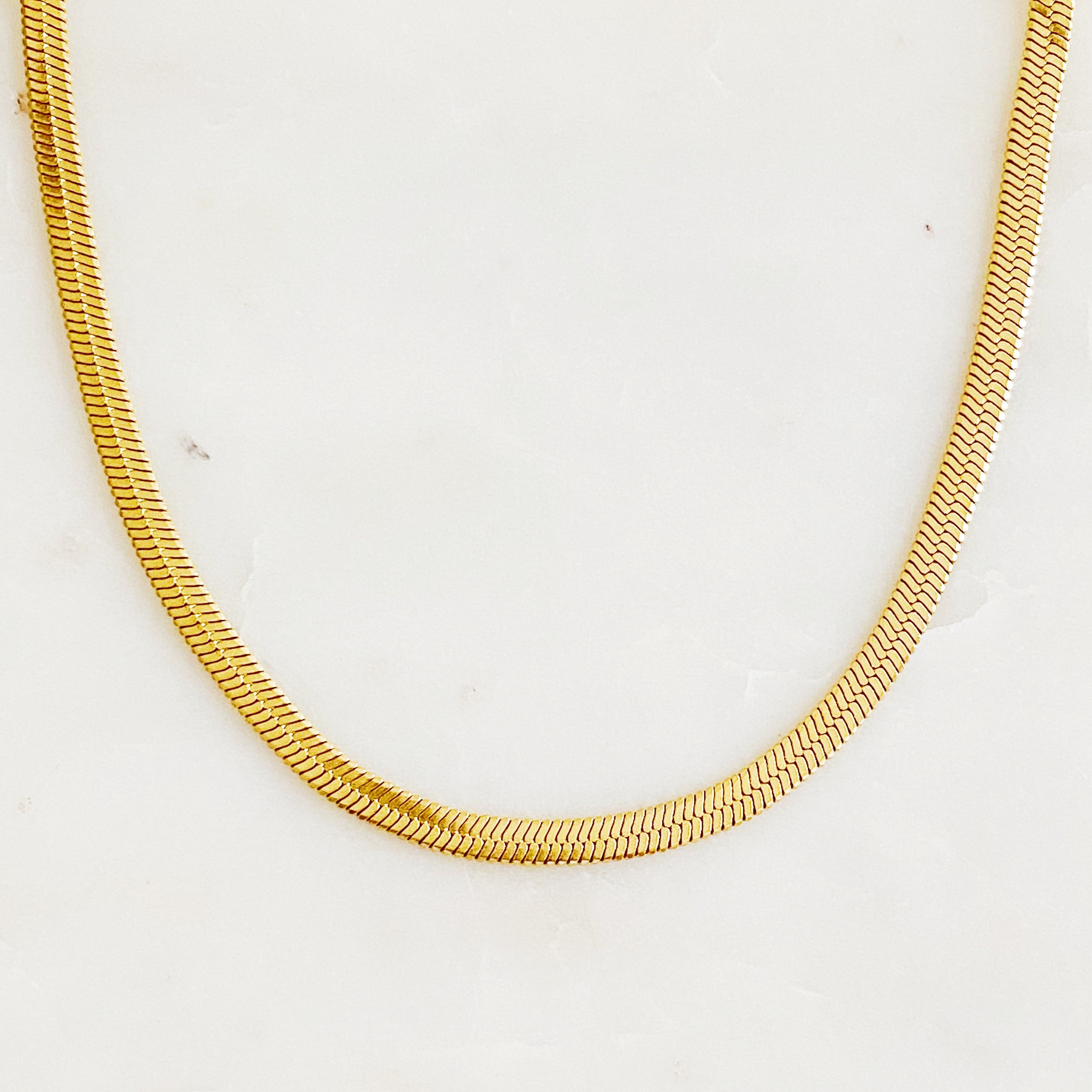 Simply Herringbone Chain Necklace featuring a classic herringbone design in stainless steel with 18K gold plating, adjustable length.