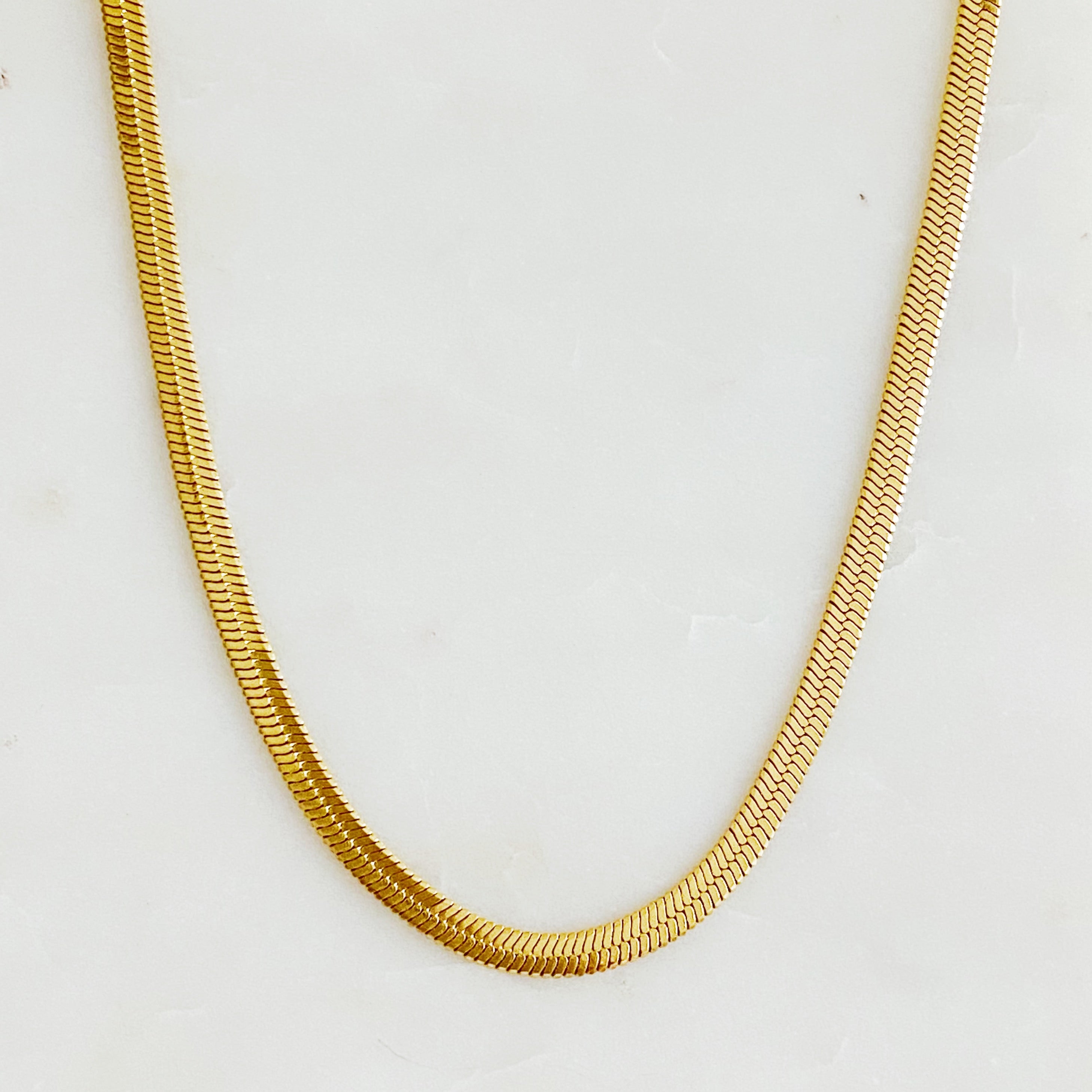 Simply Herringbone Chain Necklace featuring a classic herringbone design in stainless steel with 18K gold plating, adjustable length.