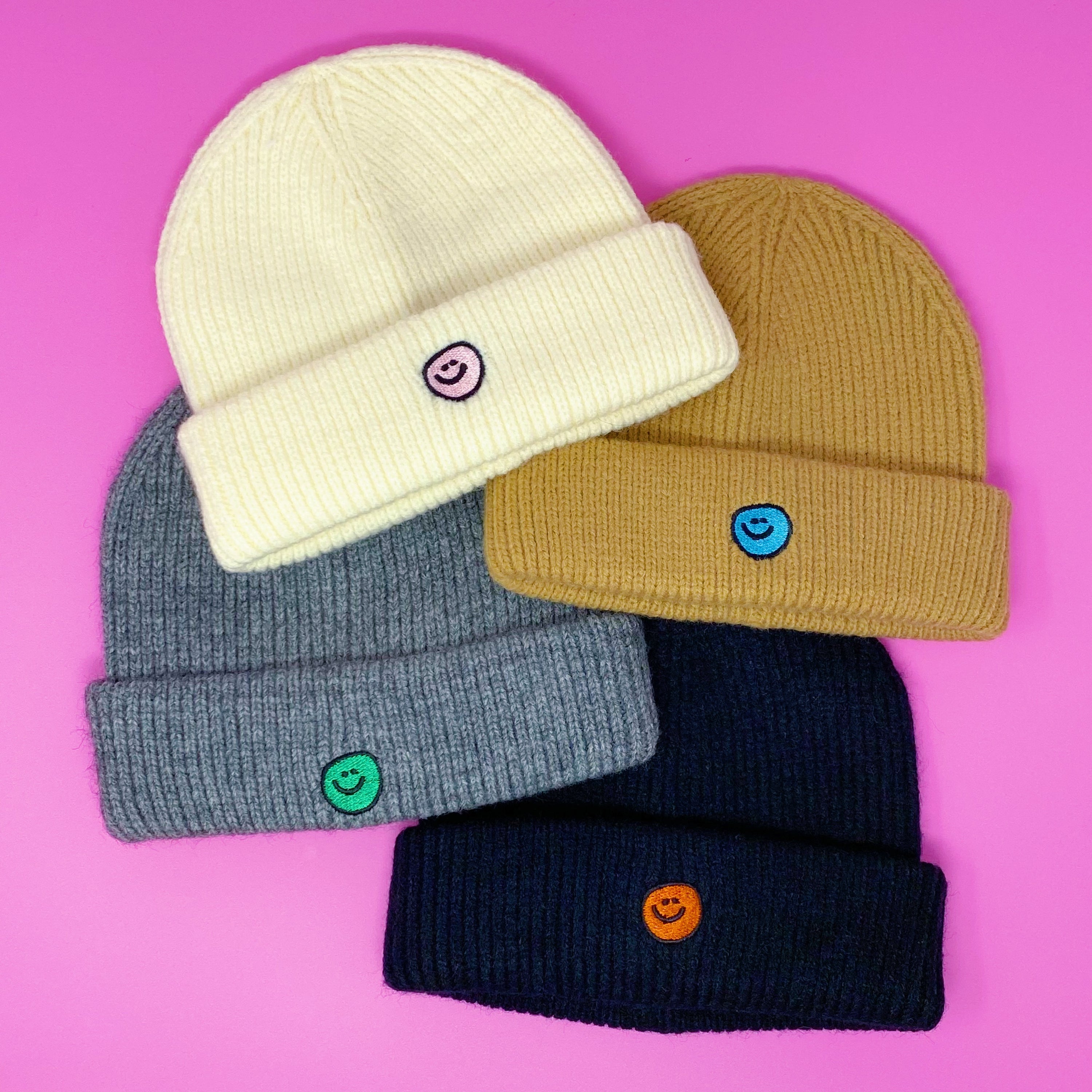 Simply Smile Beanie featuring a small happy face embroidery, made of soft acrylic material.