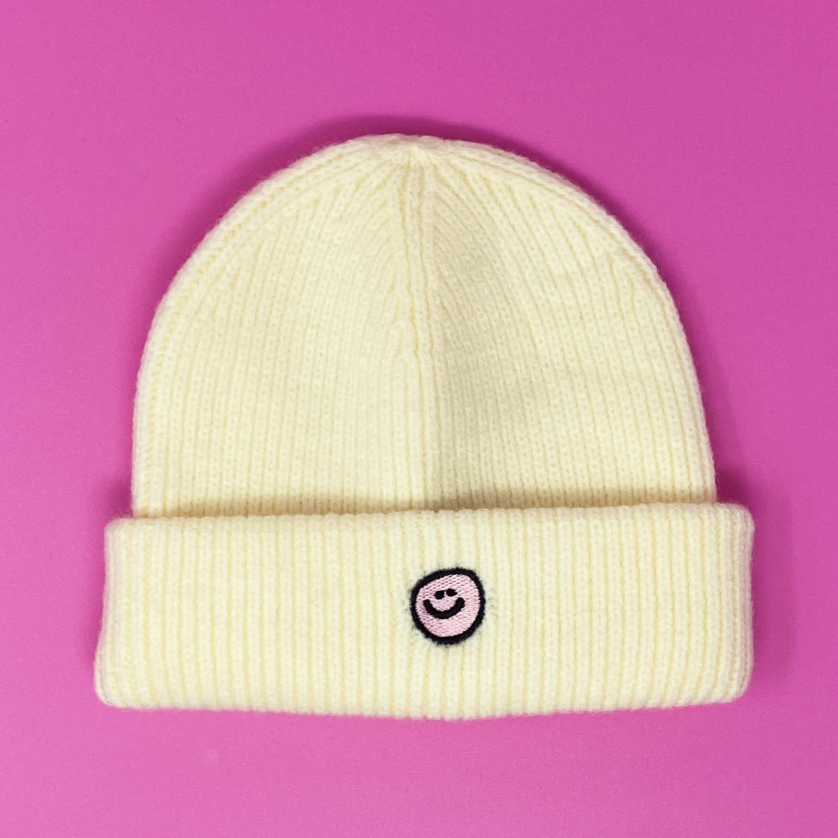 Simply Smile Beanie featuring a small happy face embroidery, made of soft acrylic material.