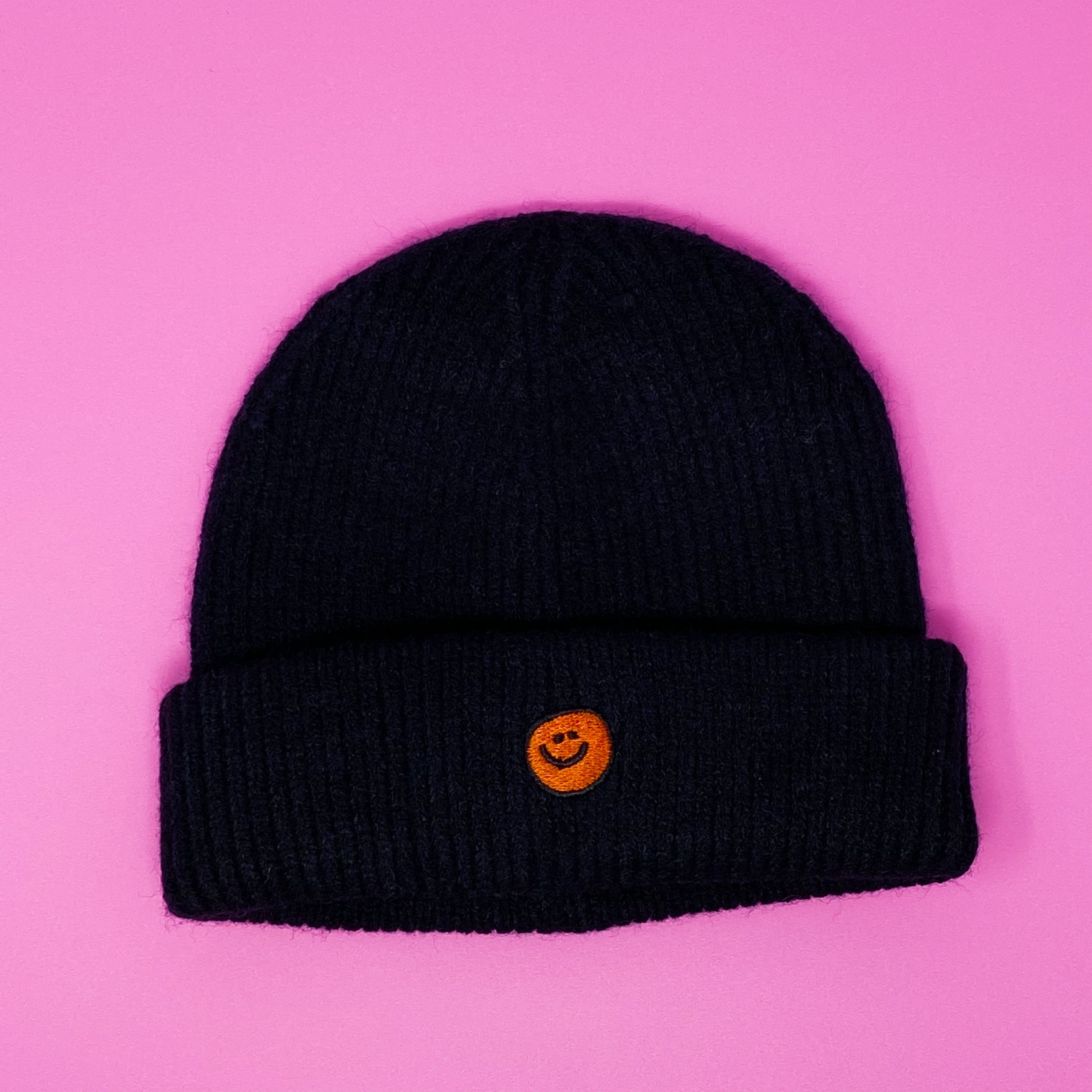 Simply Smile Beanie featuring a small happy face embroidery, made of soft acrylic material.