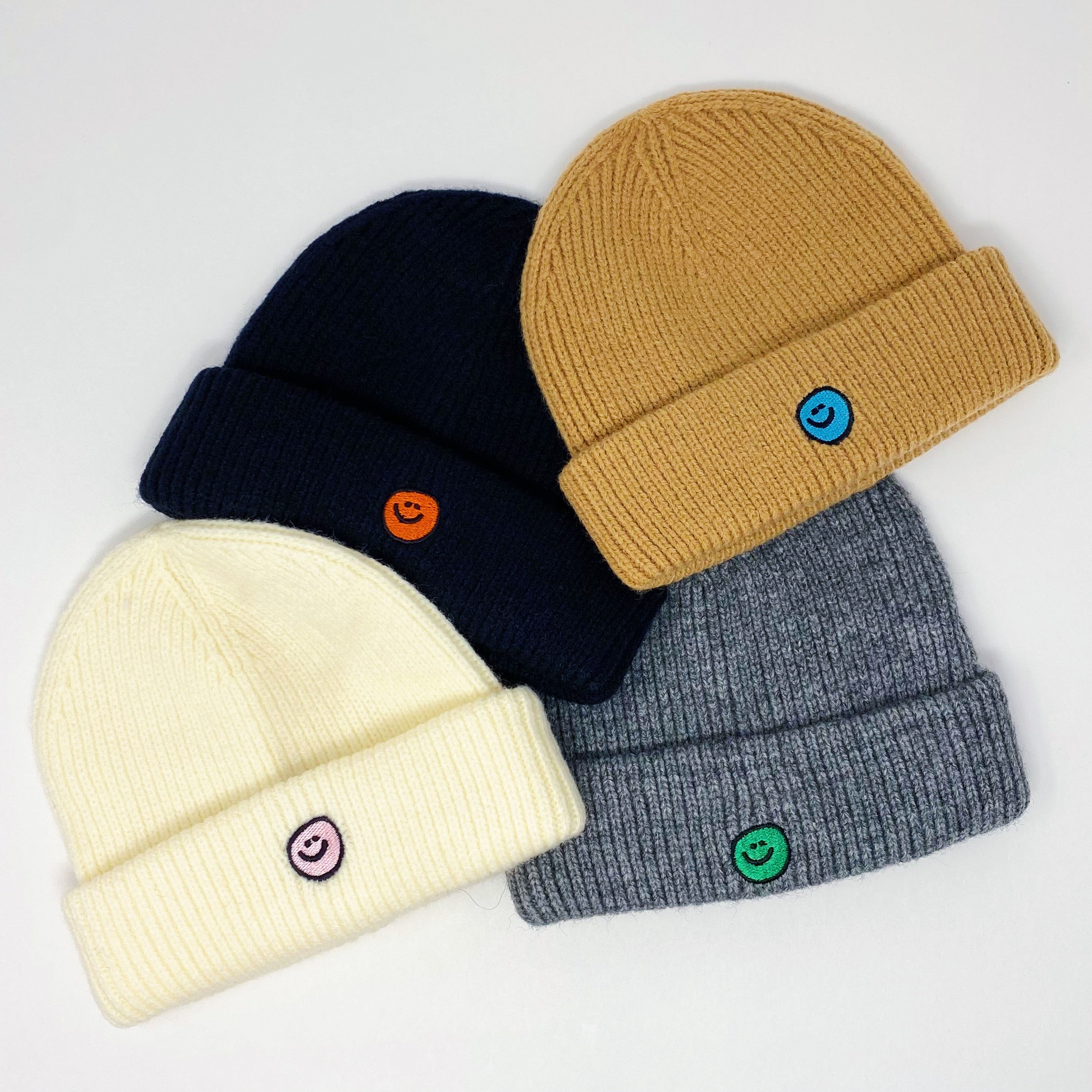 Simply Smile Beanie featuring a small happy face embroidery, made of soft acrylic material.