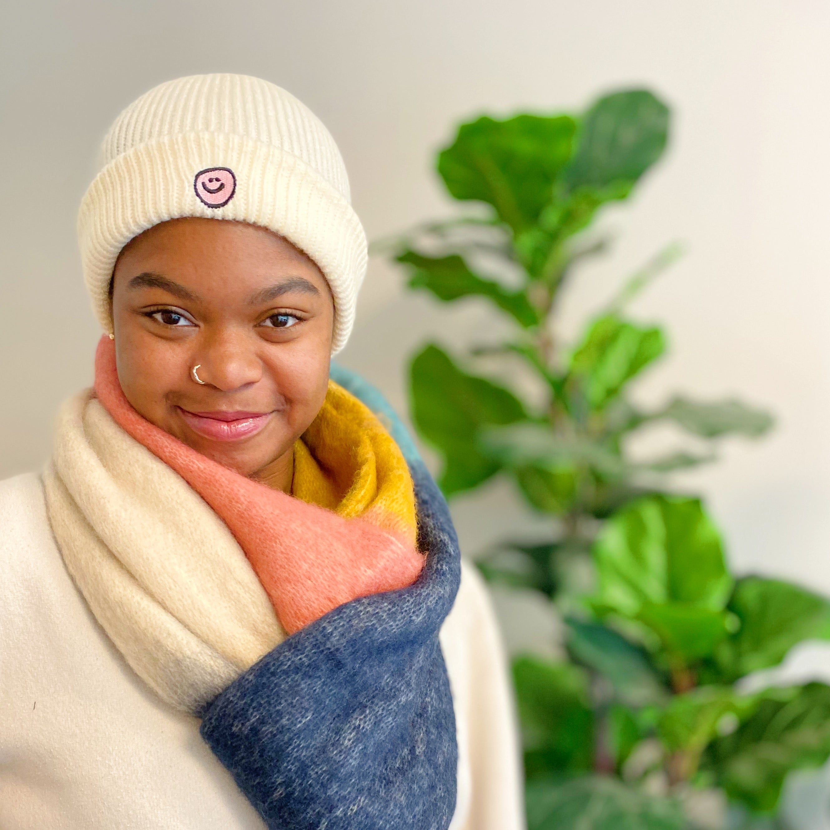 Simply Smile Beanie featuring a small happy face embroidery, made of soft acrylic material.