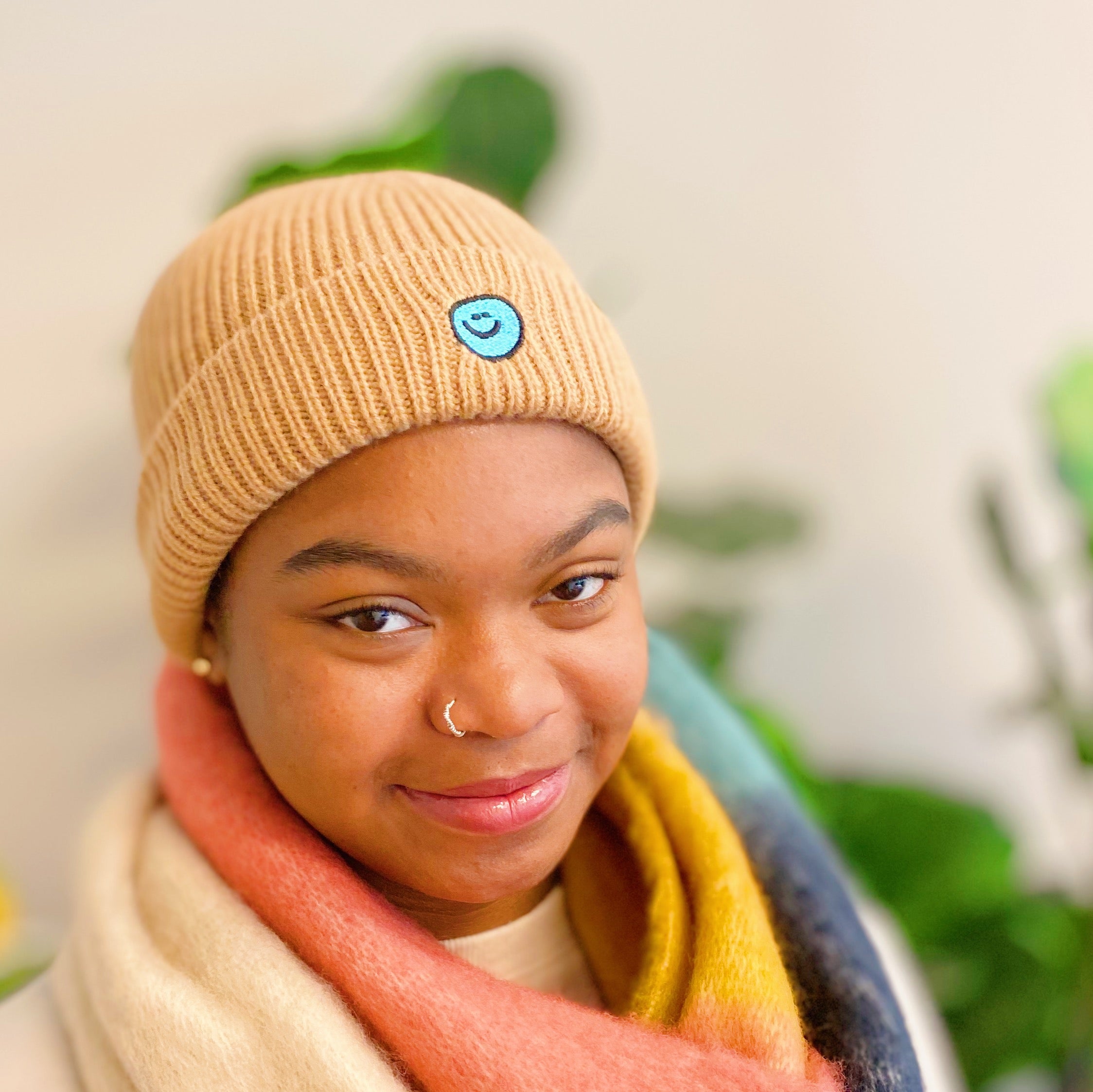 Simply Smile Beanie featuring a small happy face embroidery, made of soft acrylic material.