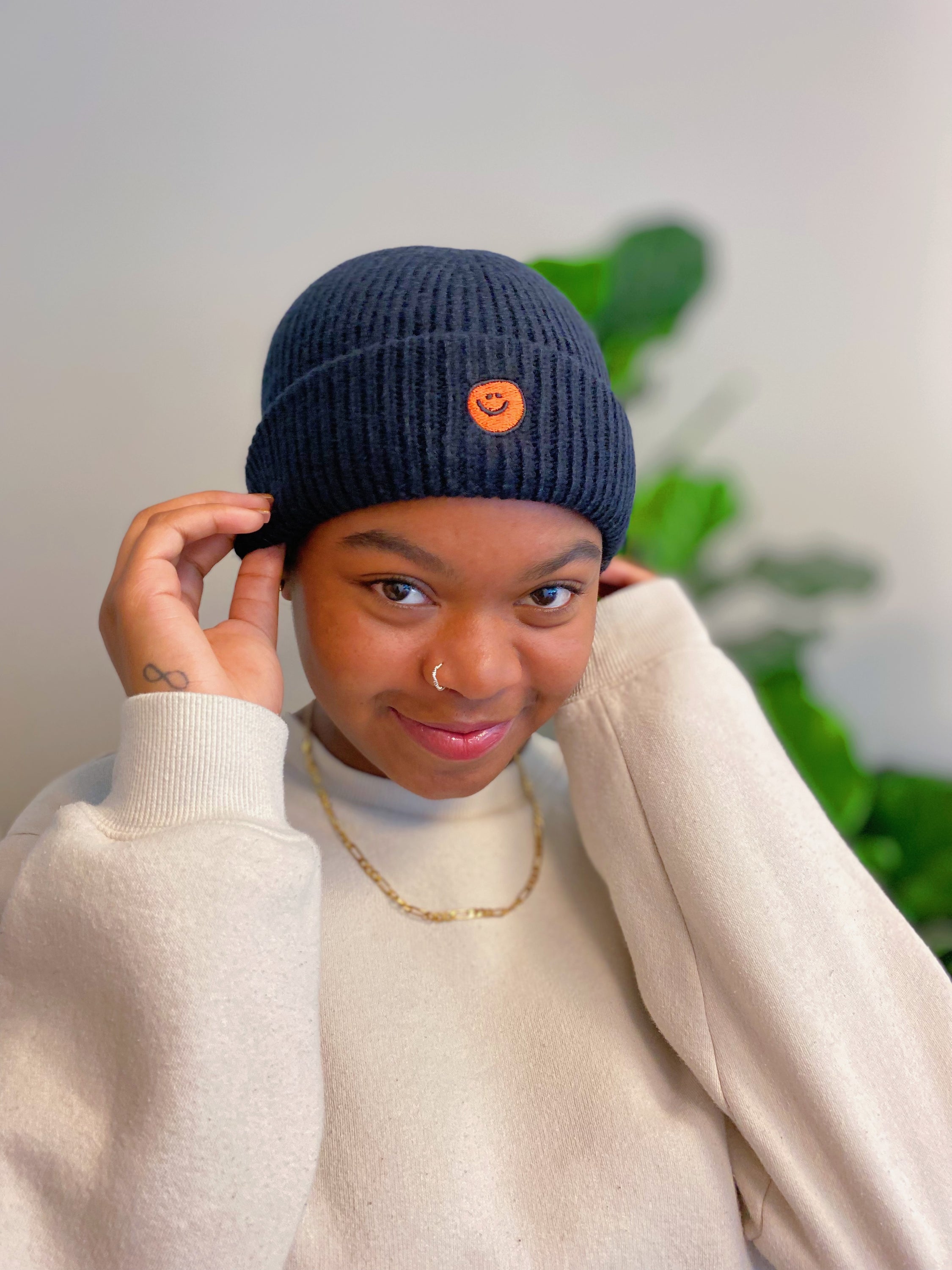 Simply Smile Beanie featuring a small happy face embroidery, made of soft acrylic material.