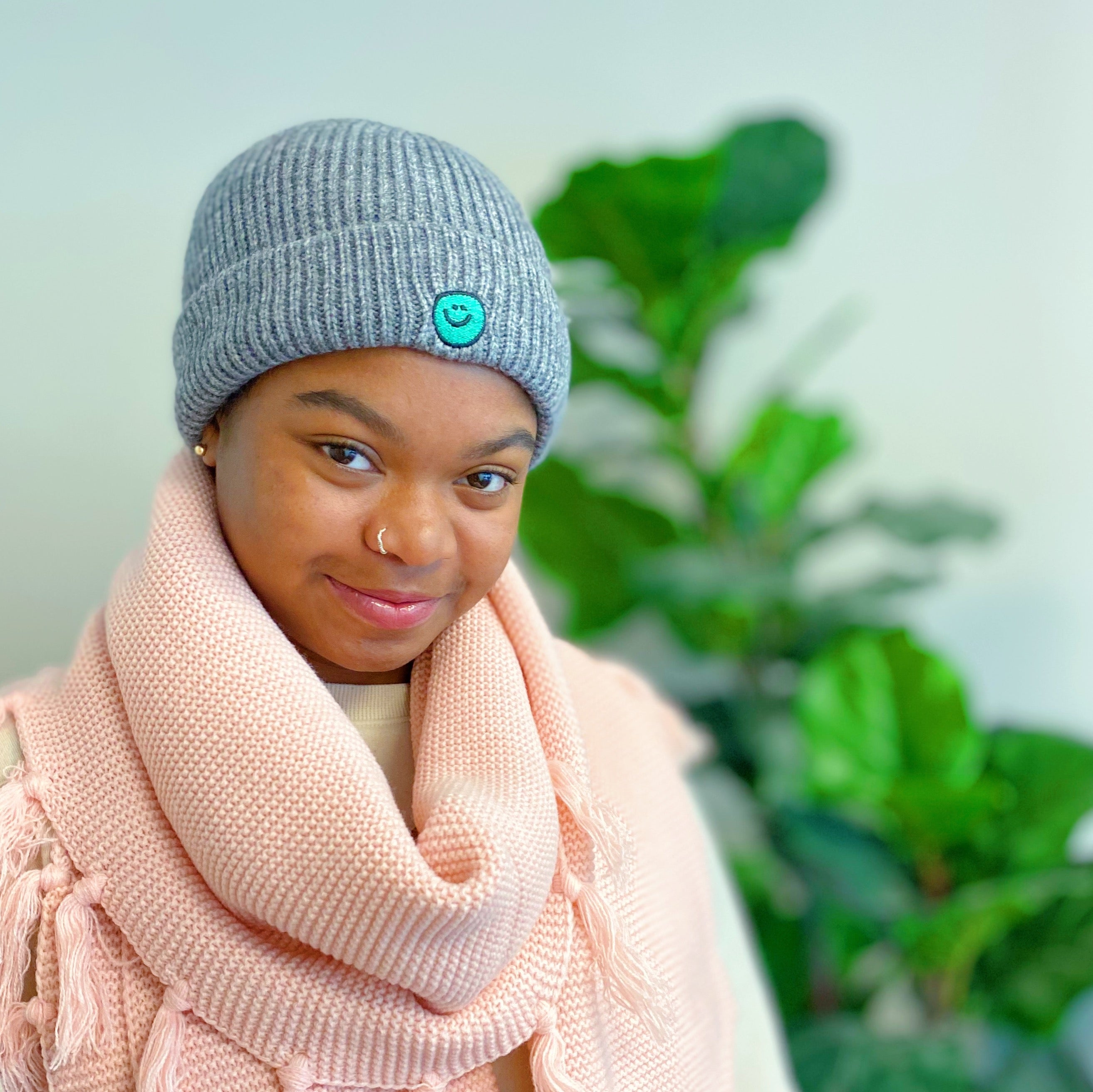 Simply Smile Beanie featuring a small happy face embroidery, made of soft acrylic material.