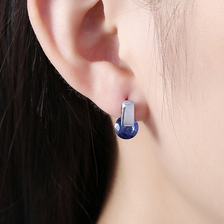 A pair of elegant Simulated Sapphire Sleek Bar Earrings set in 18K white gold, showcasing their stunning design and craftsmanship.