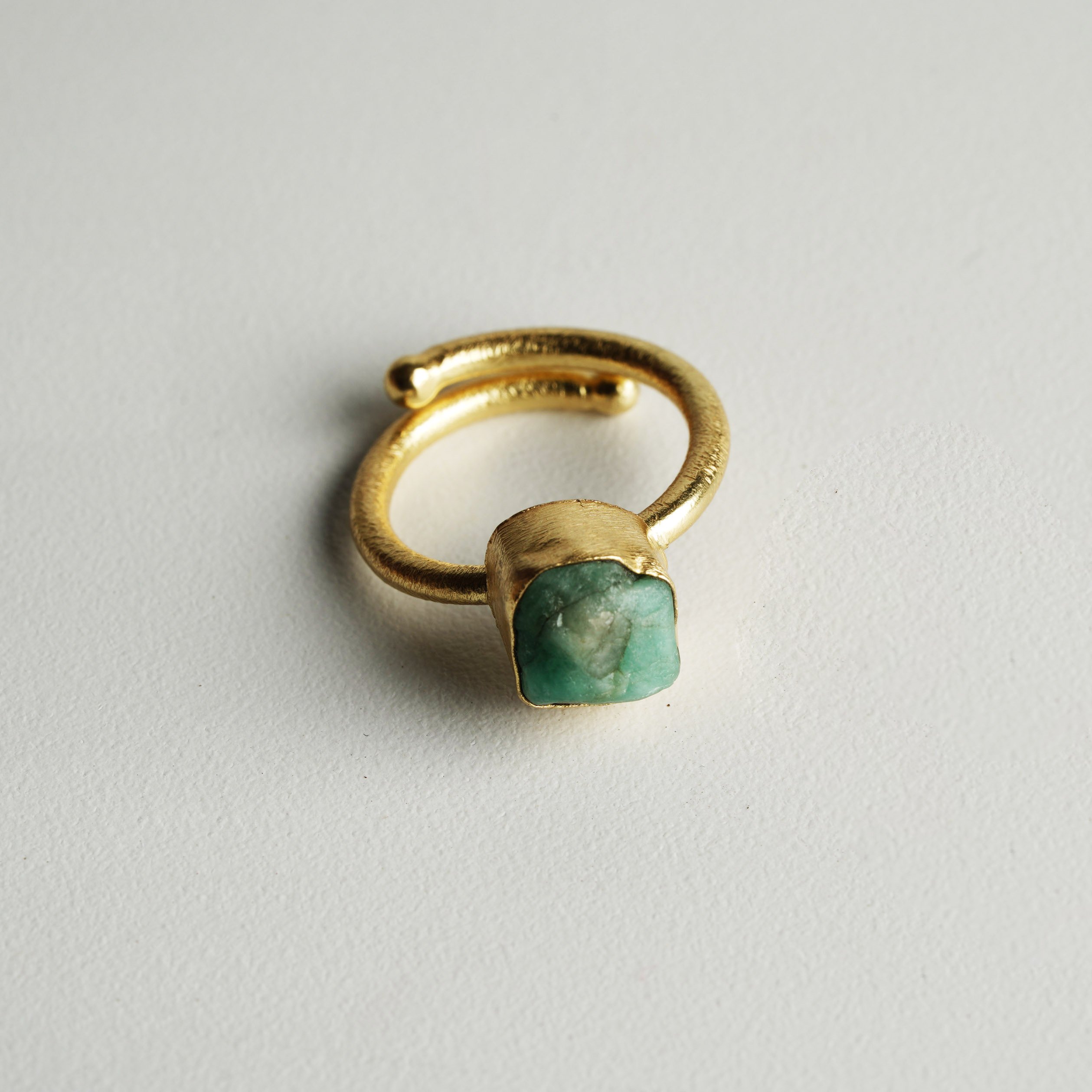 A beautifully handcrafted Single Raw Stone Ring featuring various semi-precious stones, showcasing its unique design and healing properties.