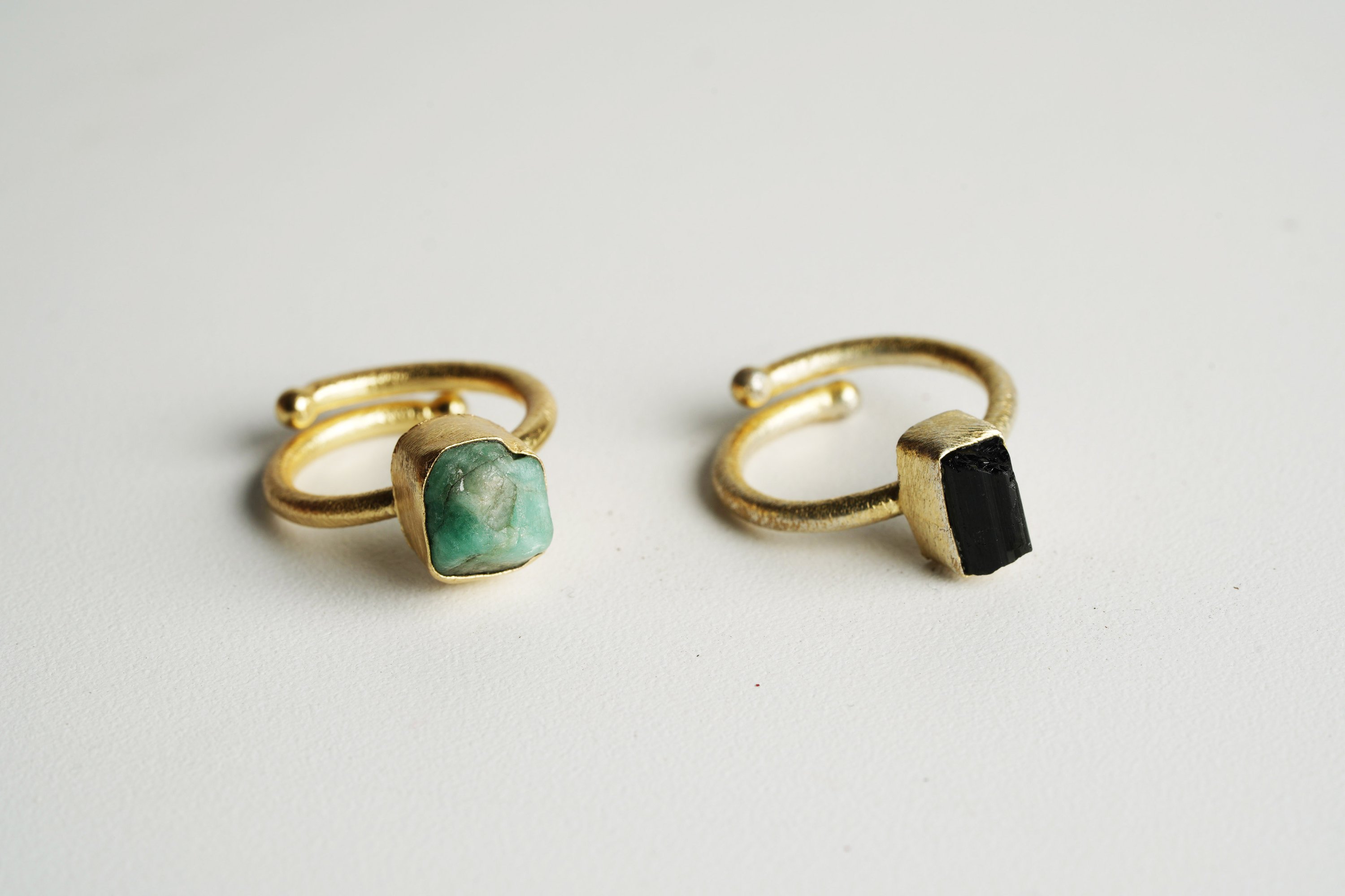 A beautifully handcrafted Single Raw Stone Ring featuring various semi-precious stones, showcasing its unique design and healing properties.