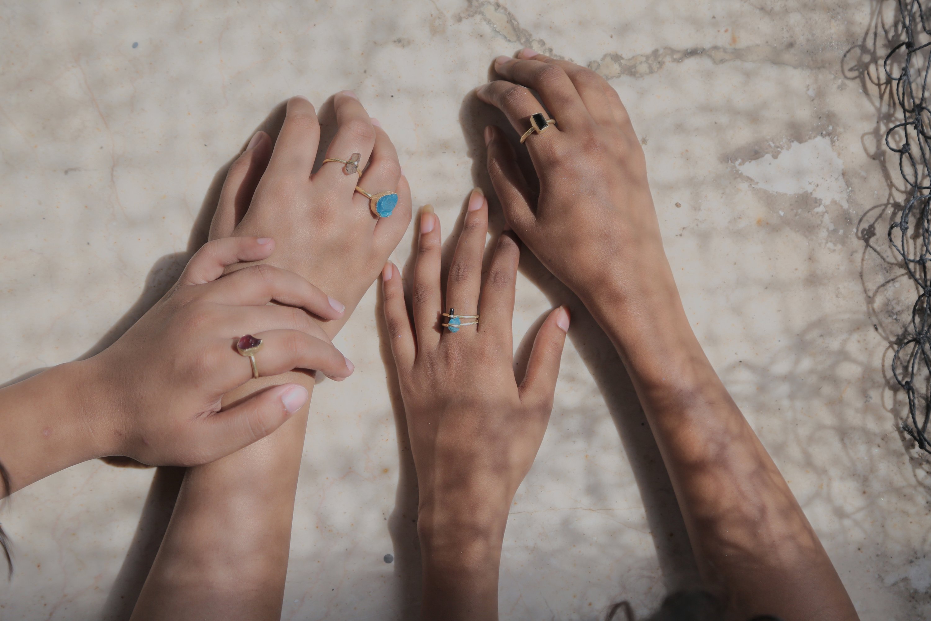 A beautifully handcrafted Single Raw Stone Ring featuring various semi-precious stones, showcasing its unique design and healing properties.