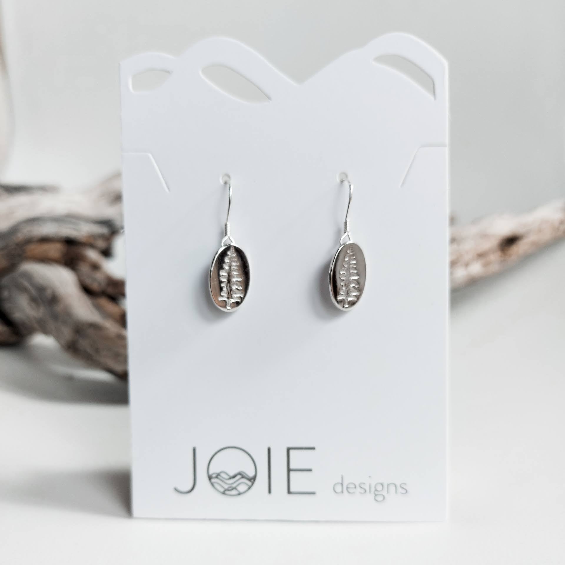 Sterling silver Sitka tree earrings in oval shape, showcasing intricate coastal designs.