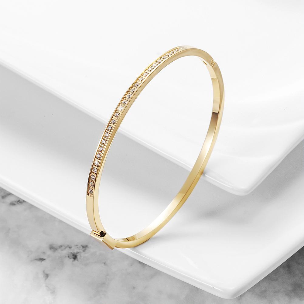 A sleek and elegant skinny stackable bangle made of 316L surgical stainless steel with 14K gold PVD plating.