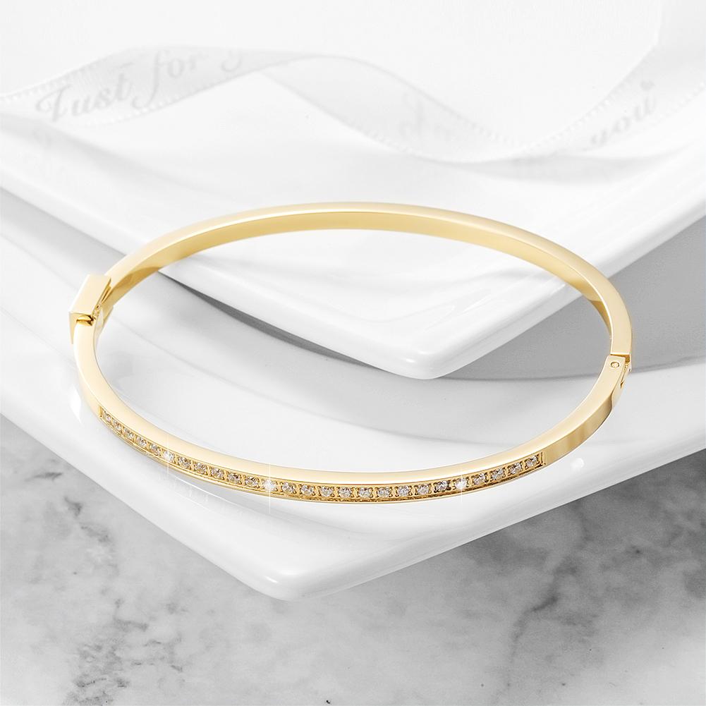 A sleek and elegant skinny stackable bangle made of 316L surgical stainless steel with 14K gold PVD plating.