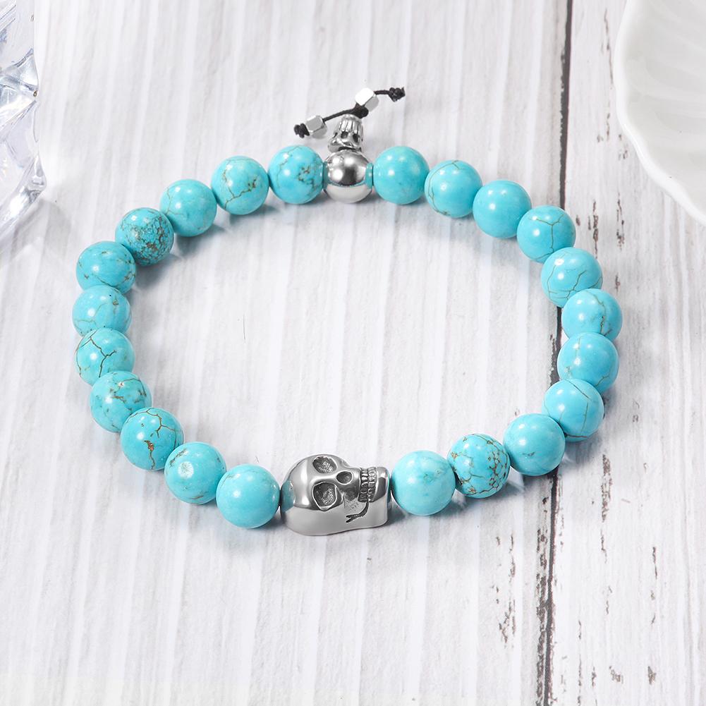 A stylish Skull Turquoise Bead Stretch Bracelet featuring skull motifs and vibrant turquoise beads on a flexible band.