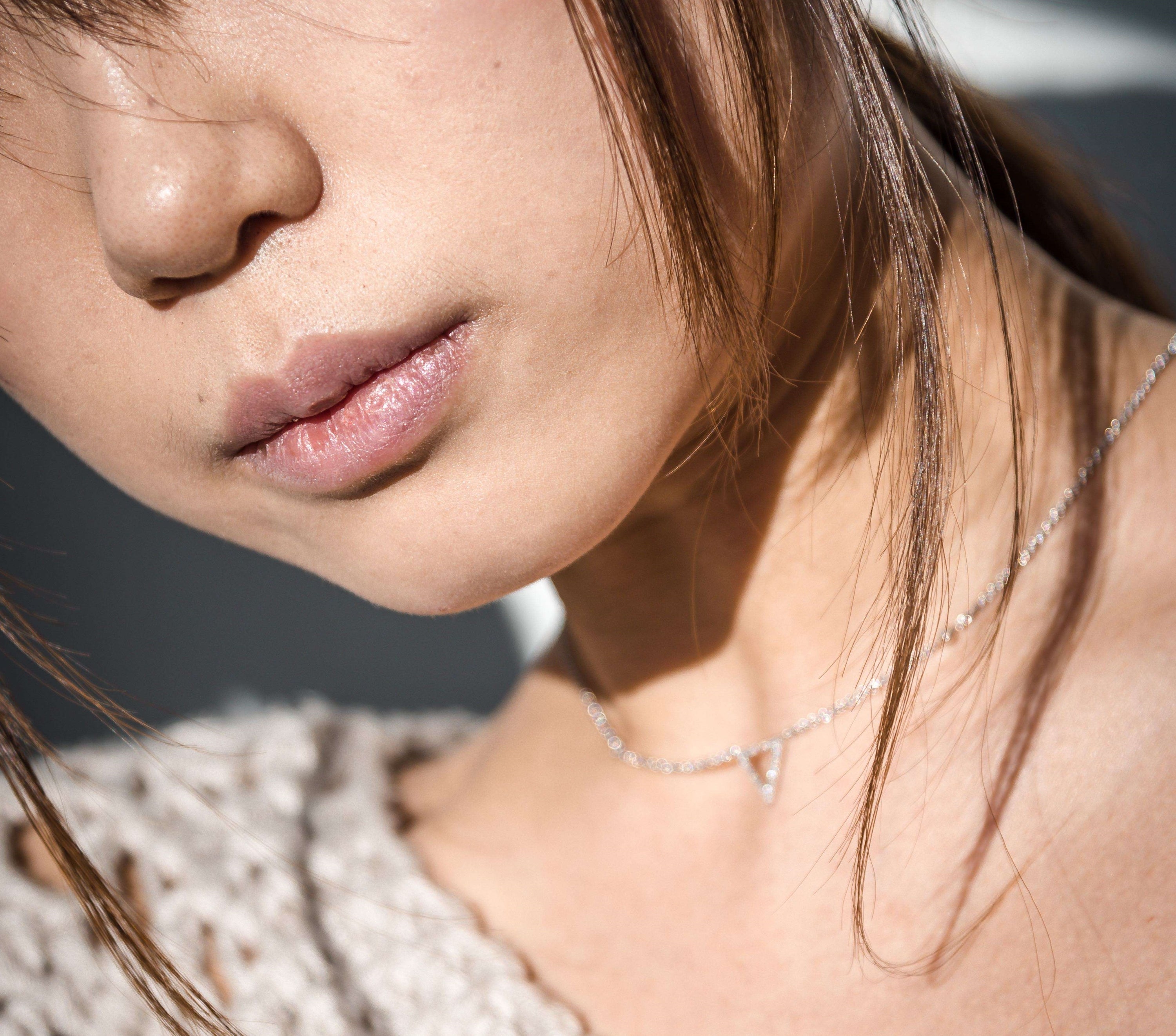 Skyline Triangle Diamond Necklace in Sterling Silver featuring genuine diamonds and a city skyline design, elegantly displayed on a soft background.