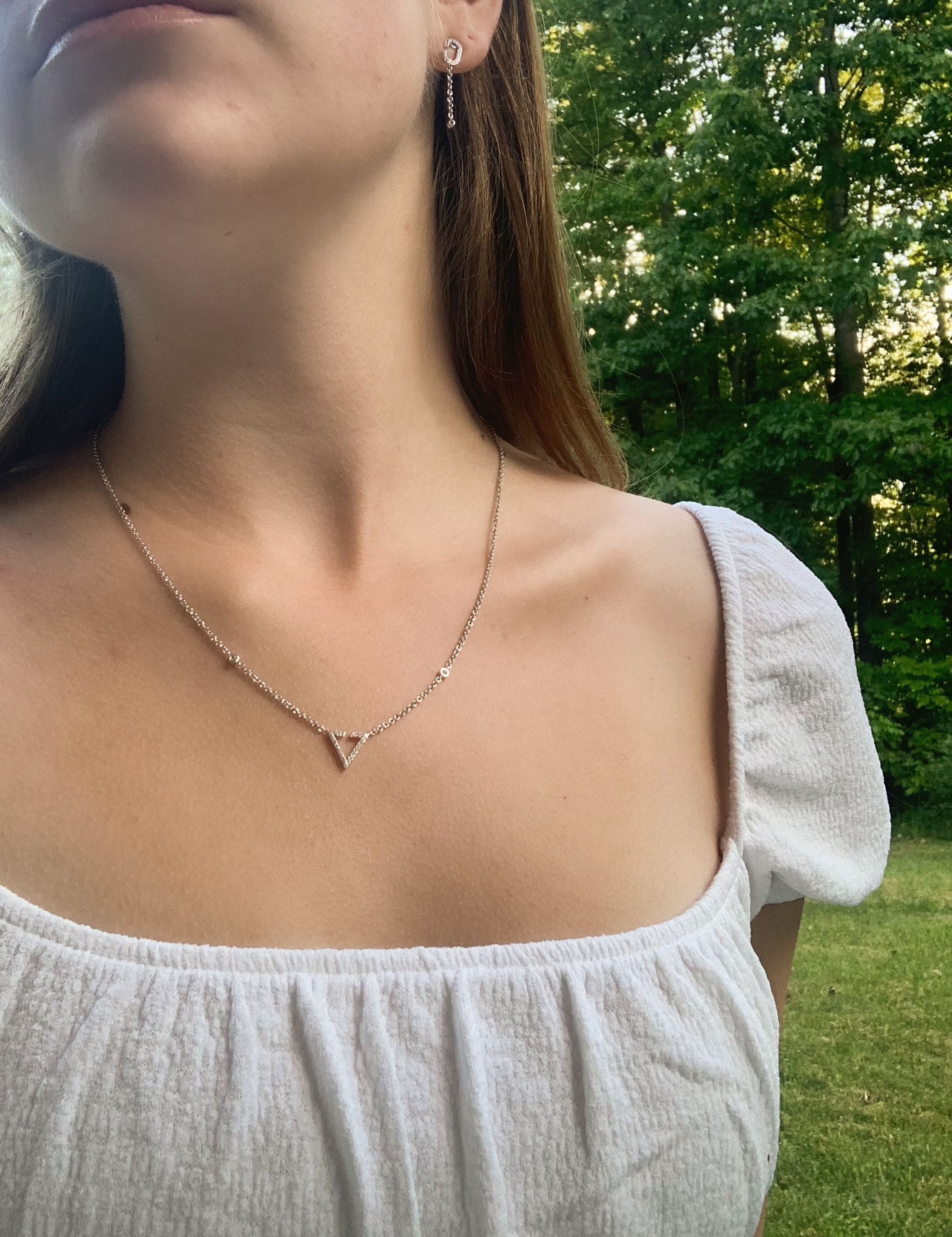 Skyline Triangle Diamond Necklace in Sterling Silver featuring genuine diamonds and a city skyline design, elegantly displayed on a soft background.