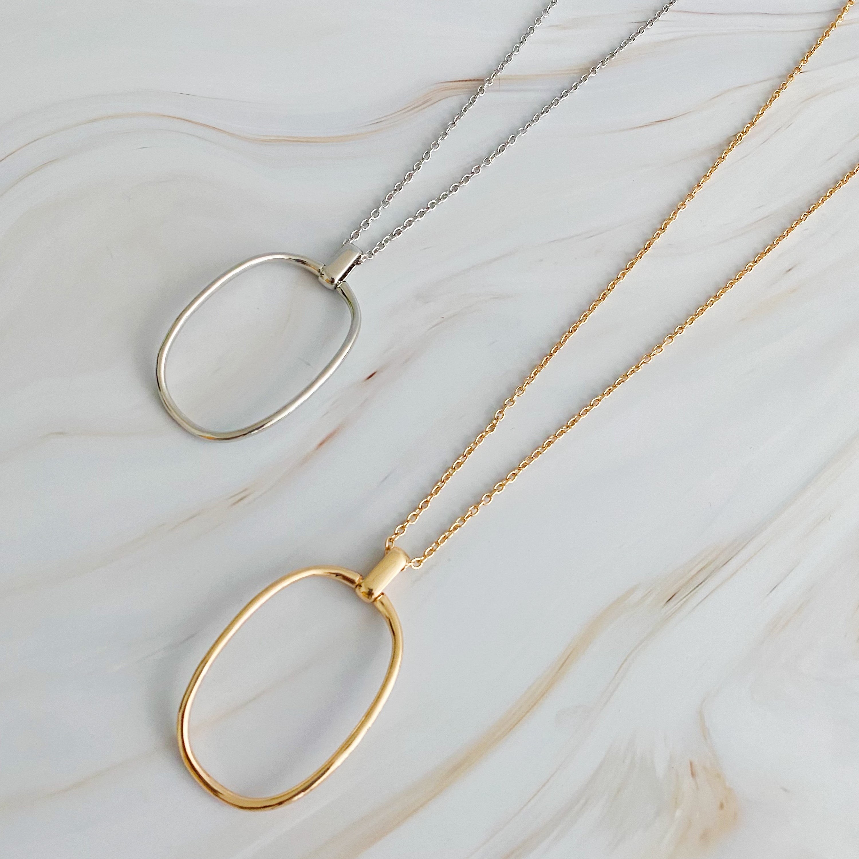 Sleek Oval Pendant Long Necklace featuring a bold oval pendant on a long chain, perfect for layering or standalone wear.