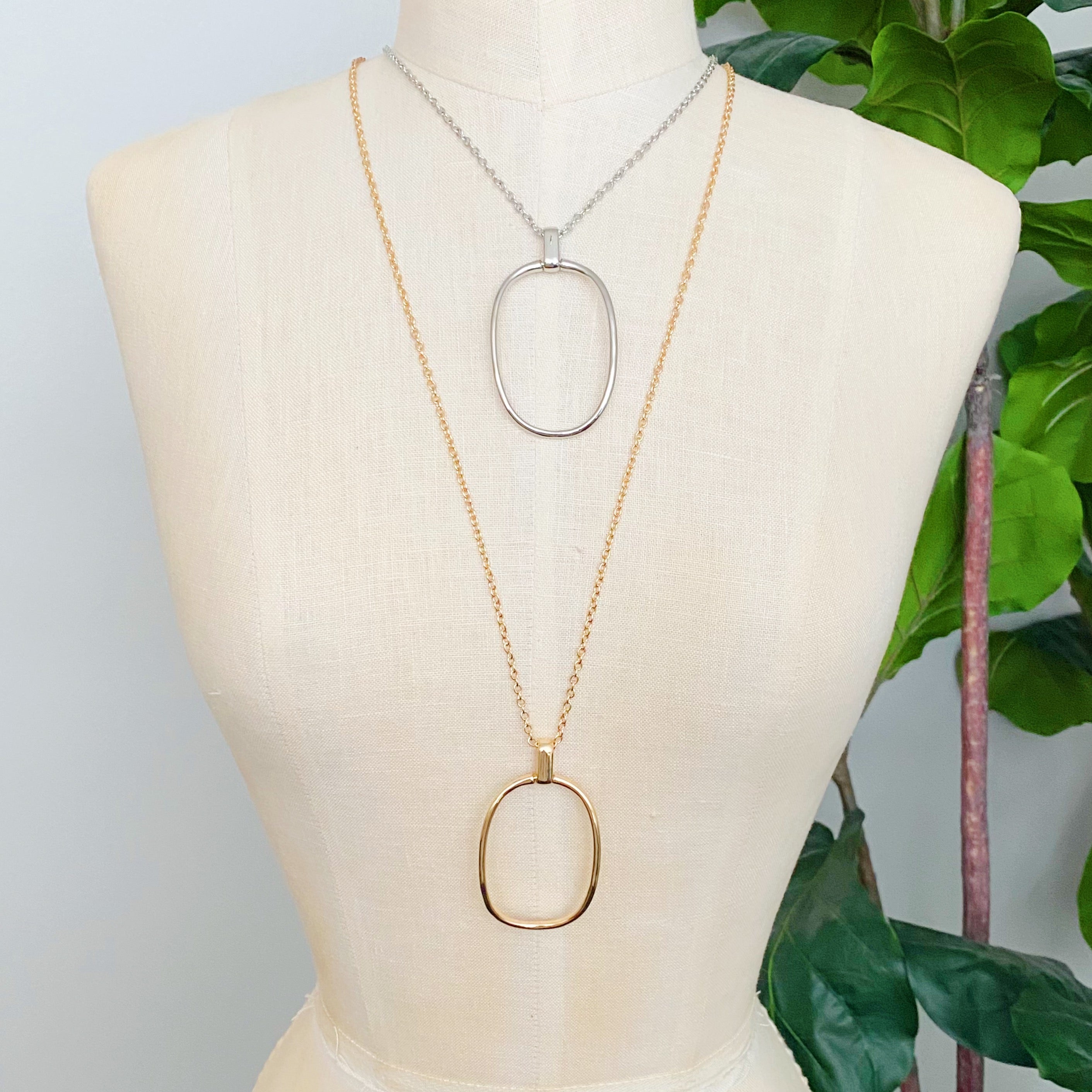 Sleek Oval Pendant Long Necklace featuring a bold oval pendant on a long chain, perfect for layering or standalone wear.