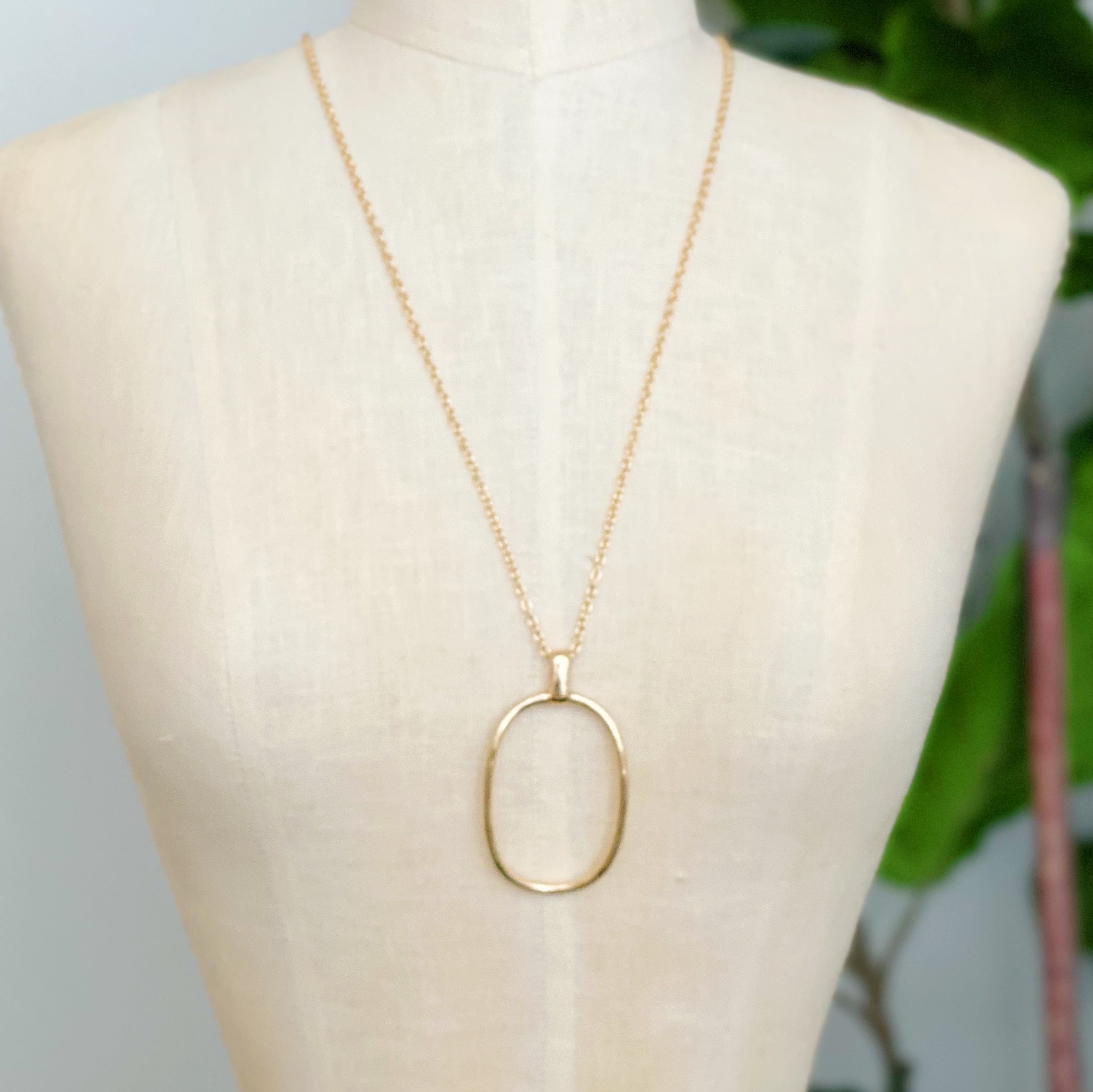 Sleek Oval Pendant Long Necklace featuring a bold oval pendant on a long chain, perfect for layering or standalone wear.