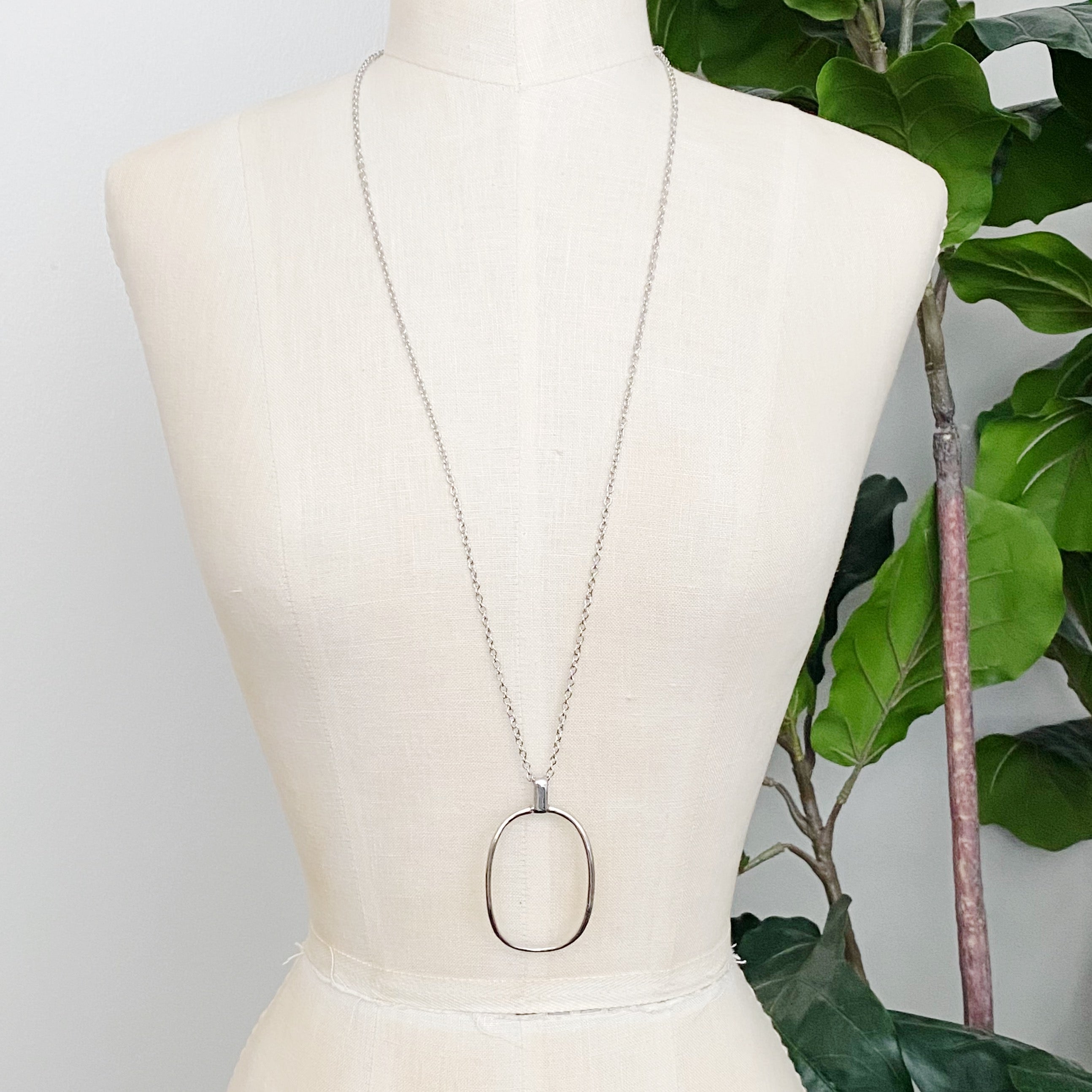 Sleek Oval Pendant Long Necklace featuring a bold oval pendant on a long chain, perfect for layering or standalone wear.