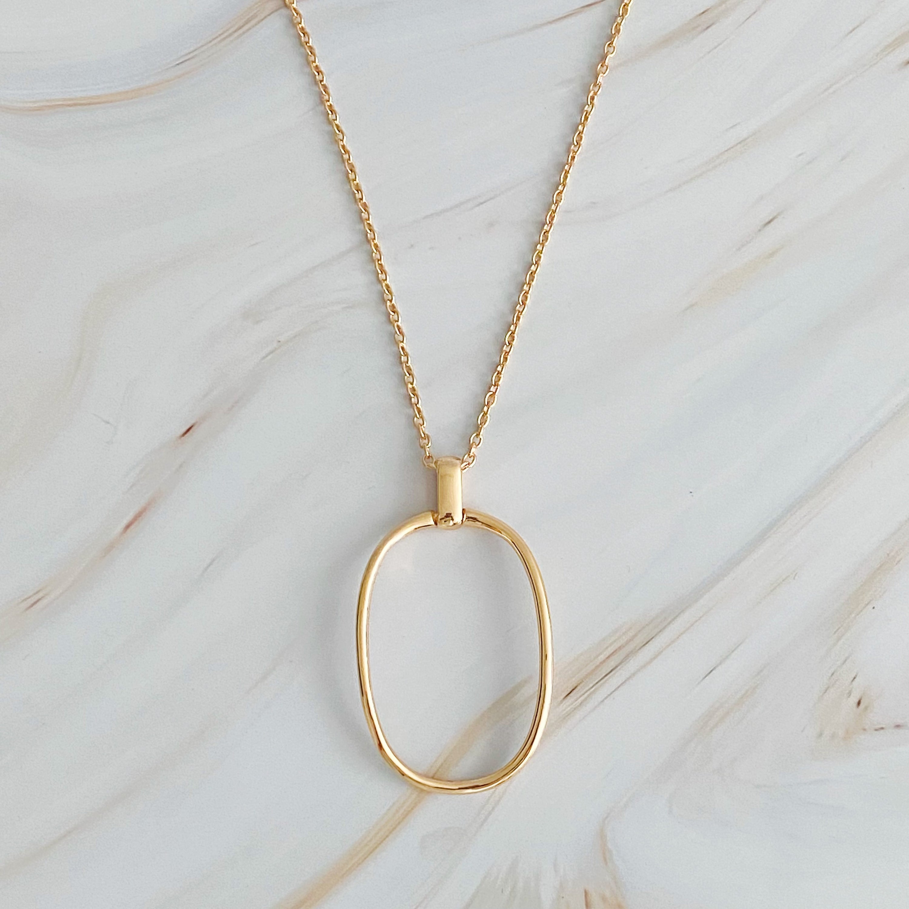 Sleek Oval Pendant Long Necklace featuring a bold oval pendant on a long chain, perfect for layering or standalone wear.