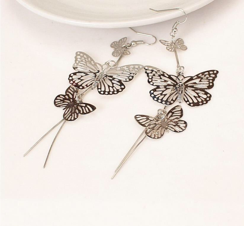 A pair of large, stylish butterfly earrings made from alloy, measuring 10cm by 3.8cm, showcasing intricate design and elegance.