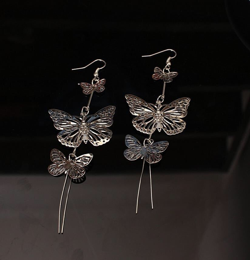 A pair of large, stylish butterfly earrings made from alloy, measuring 10cm by 3.8cm, showcasing intricate design and elegance.