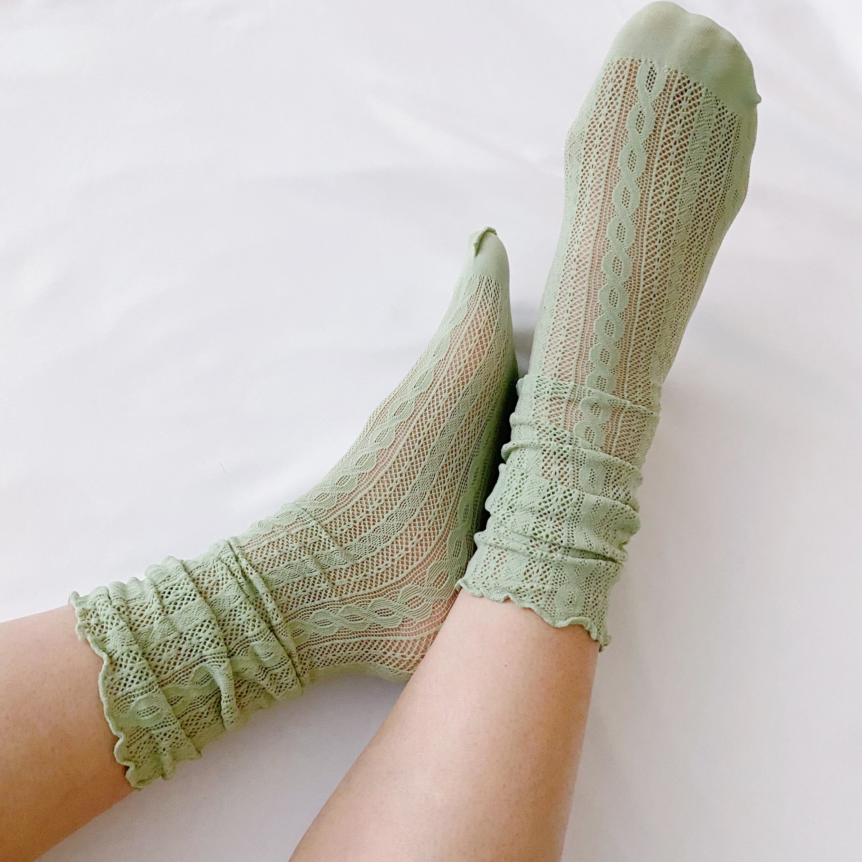 A stylish set of two slouch crochet lace socks in elegant design, showcasing their lightweight and comfortable fabric.