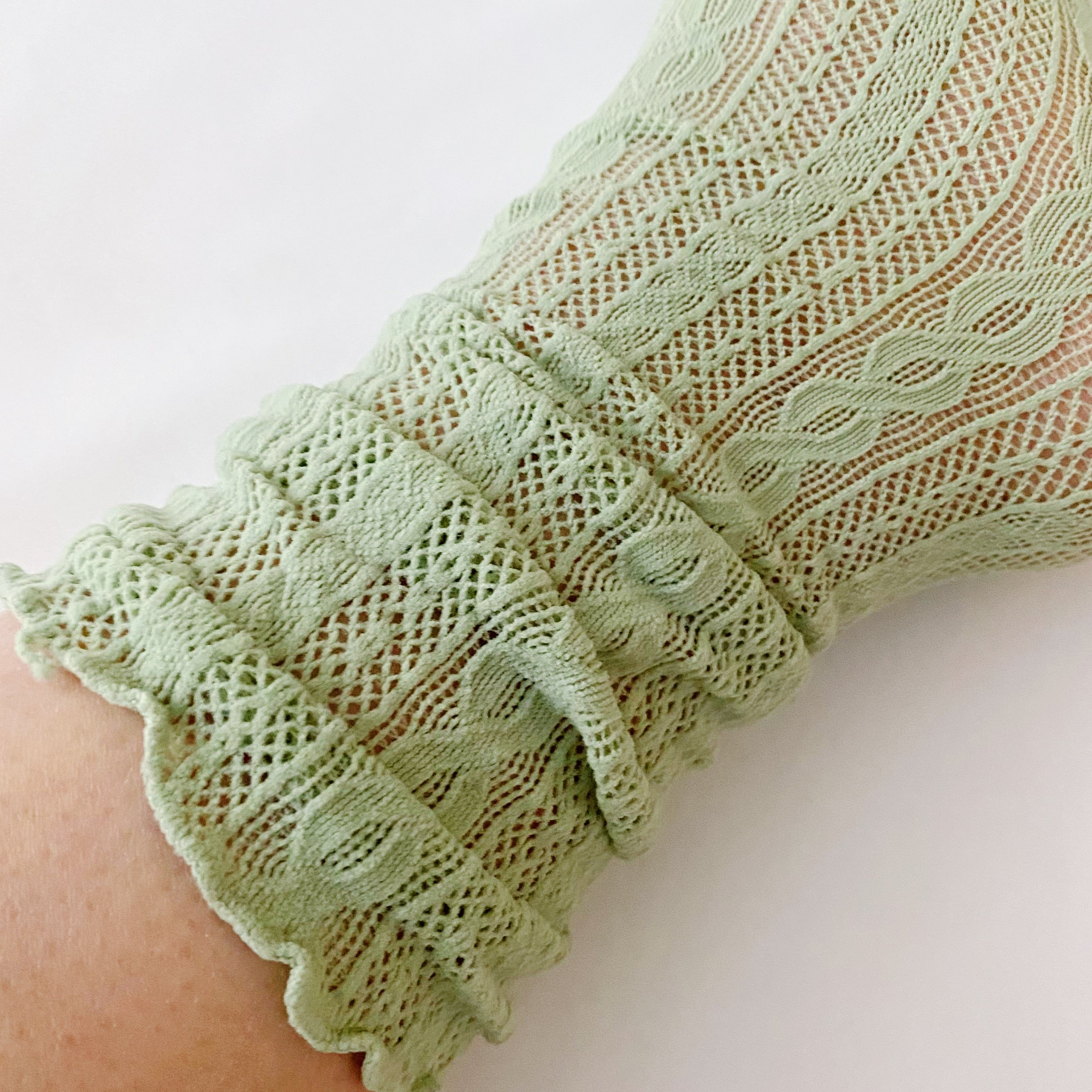 A stylish set of two slouch crochet lace socks in elegant design, showcasing their lightweight and comfortable fabric.