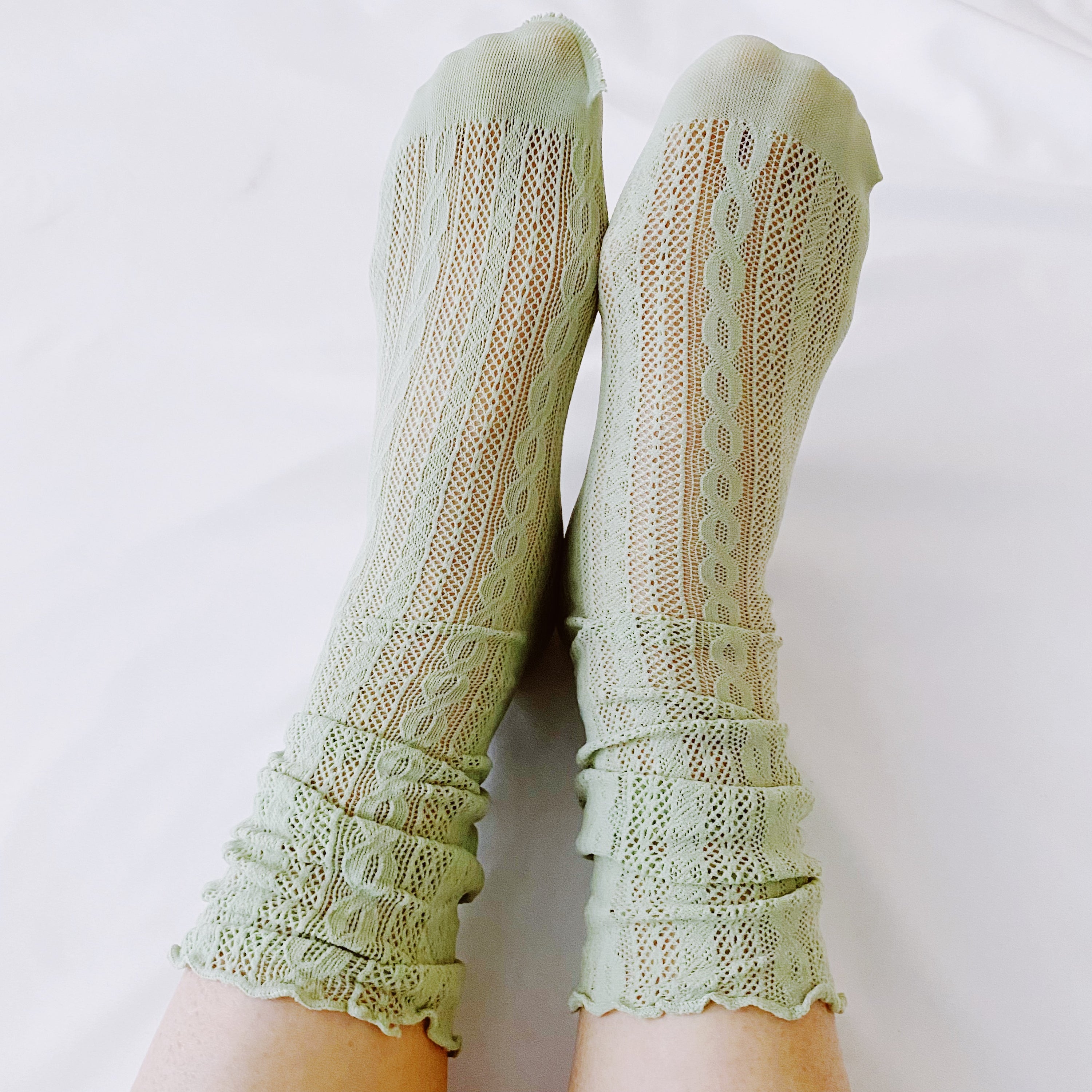 A stylish set of two slouch crochet lace socks in elegant design, showcasing their lightweight and comfortable fabric.